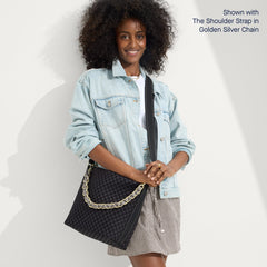 The Mini Zip Bucket in Black Sand, carried over the shoulder of a female model, shown from the front.