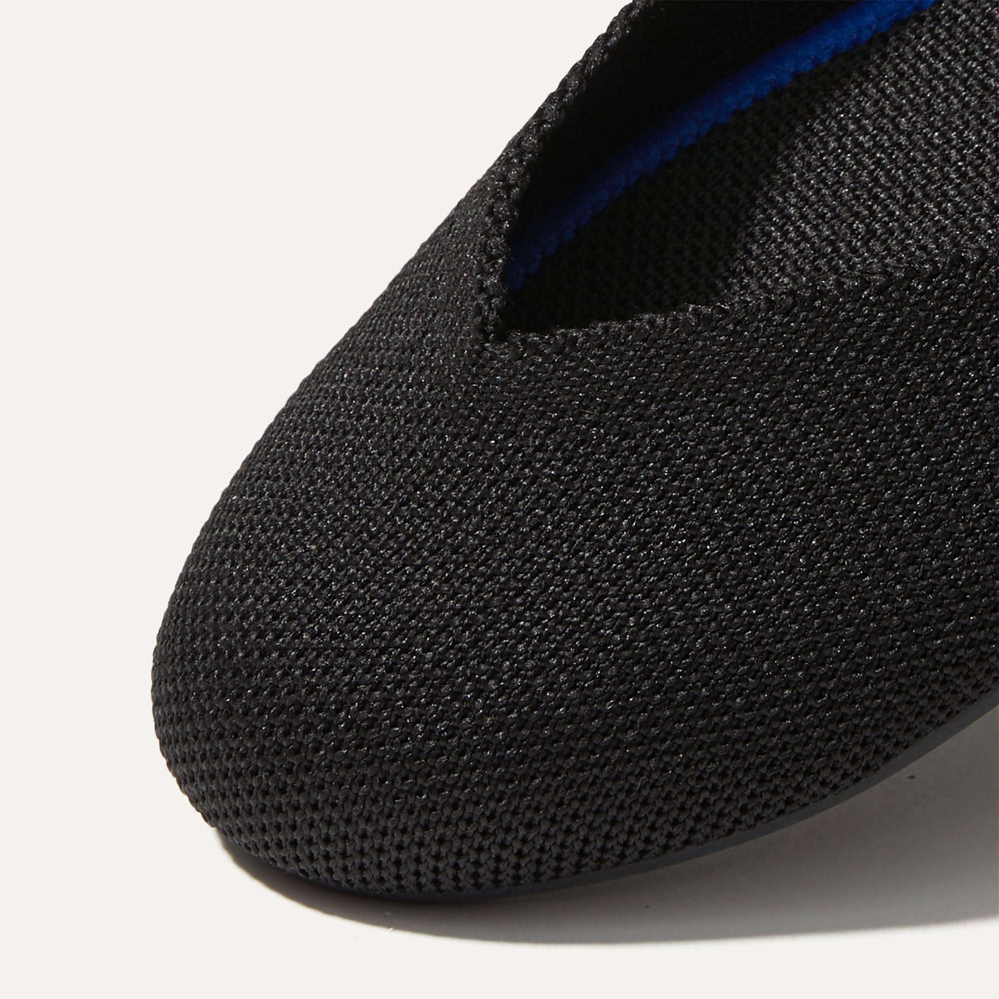 The Flat round toe shoe in Black Solid shown from the top view with detailing of the front of the shoe.