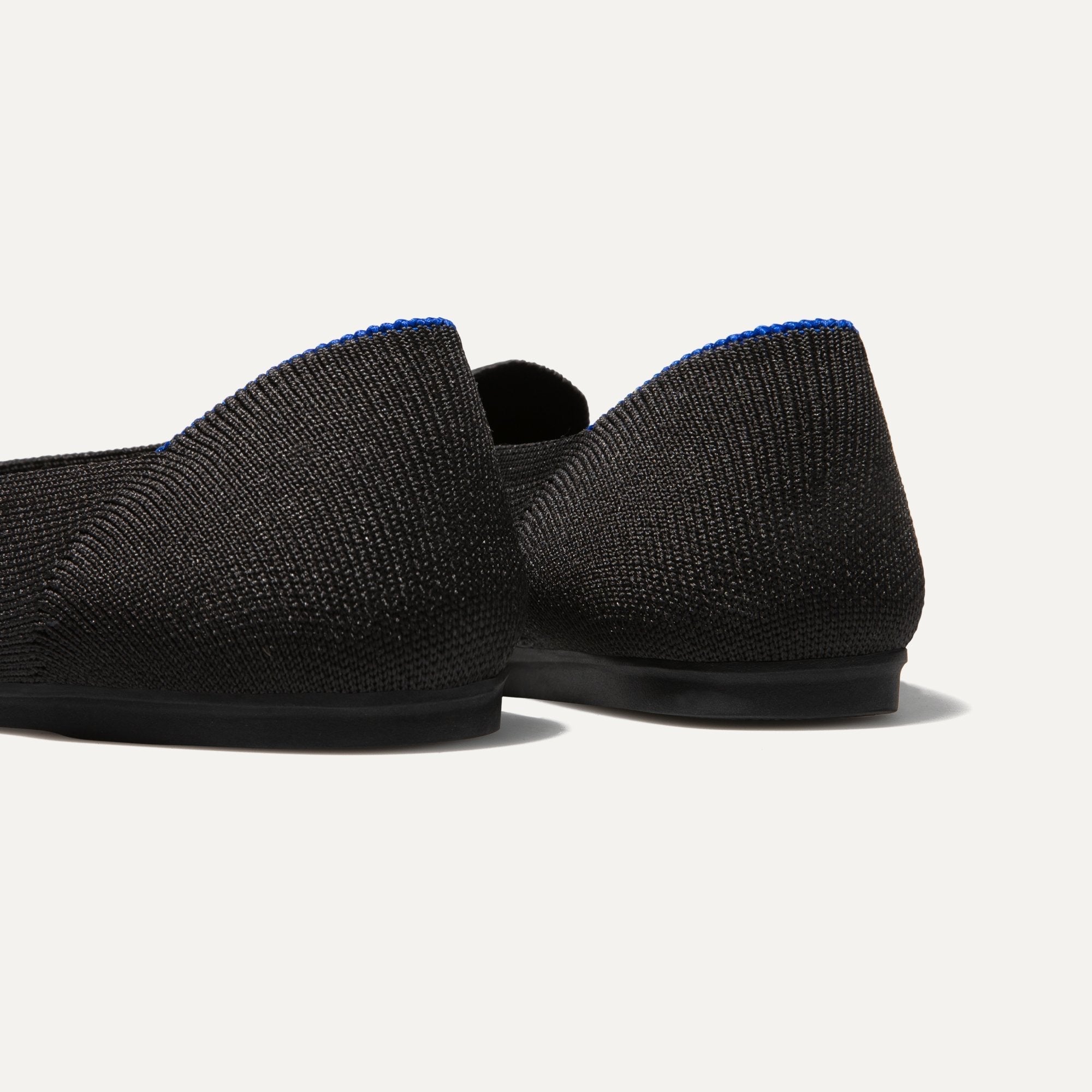 The Loafer in Black Solid shown from the back view with the heel detail.