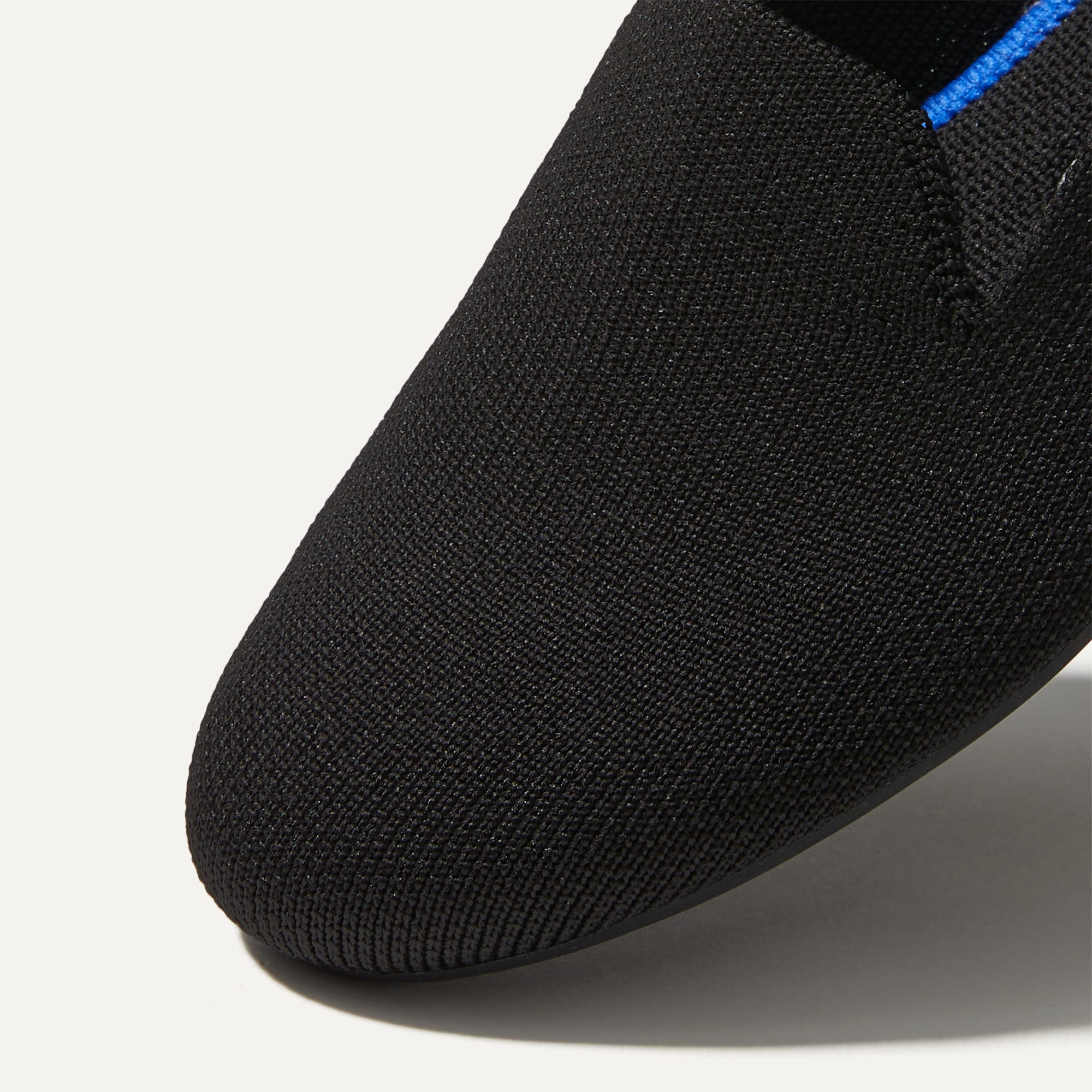 The Loafer in Black Solid shown from the top view with detailing of the front of the shoe.