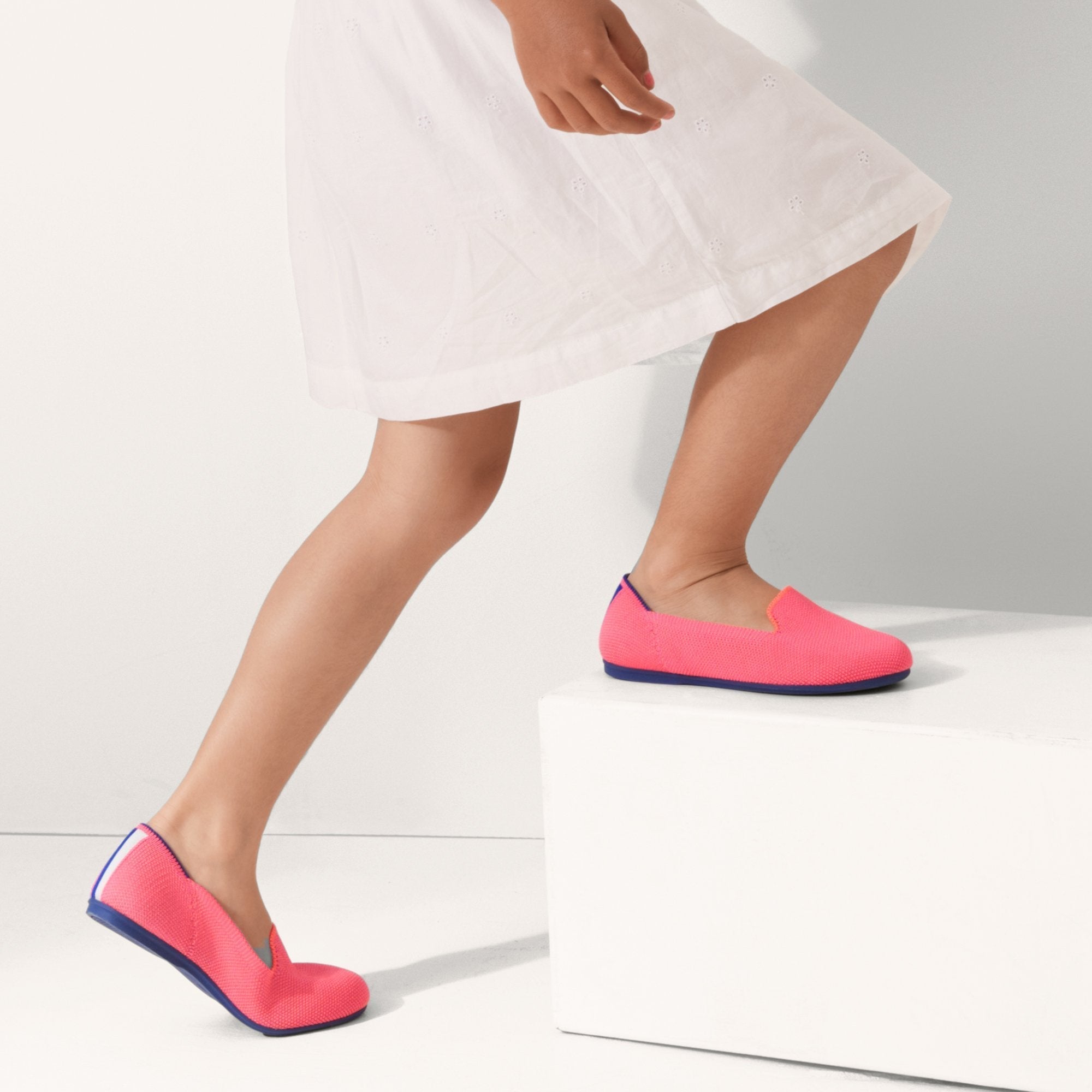 hover | The Kids slip-on Loafer in Flamingo shown on-model at an angle.