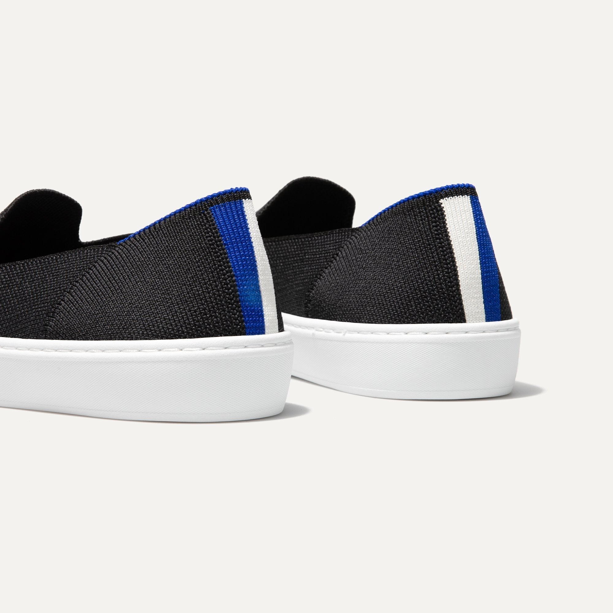 The slip-on Sneaker in Black Solid shown from the back view with the heel detail.