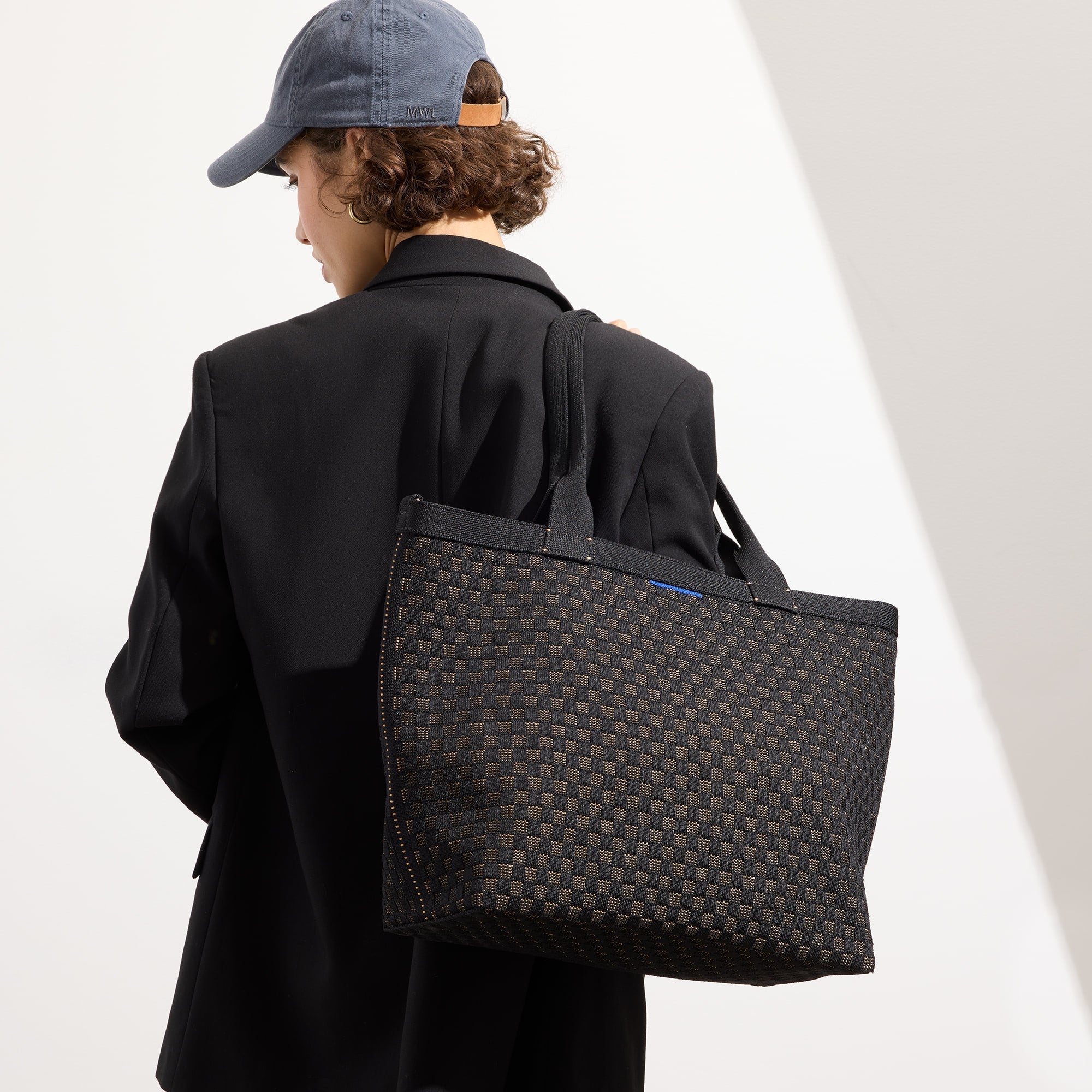 hover | Model holding The Lightweight Zip Tote in Night Song.