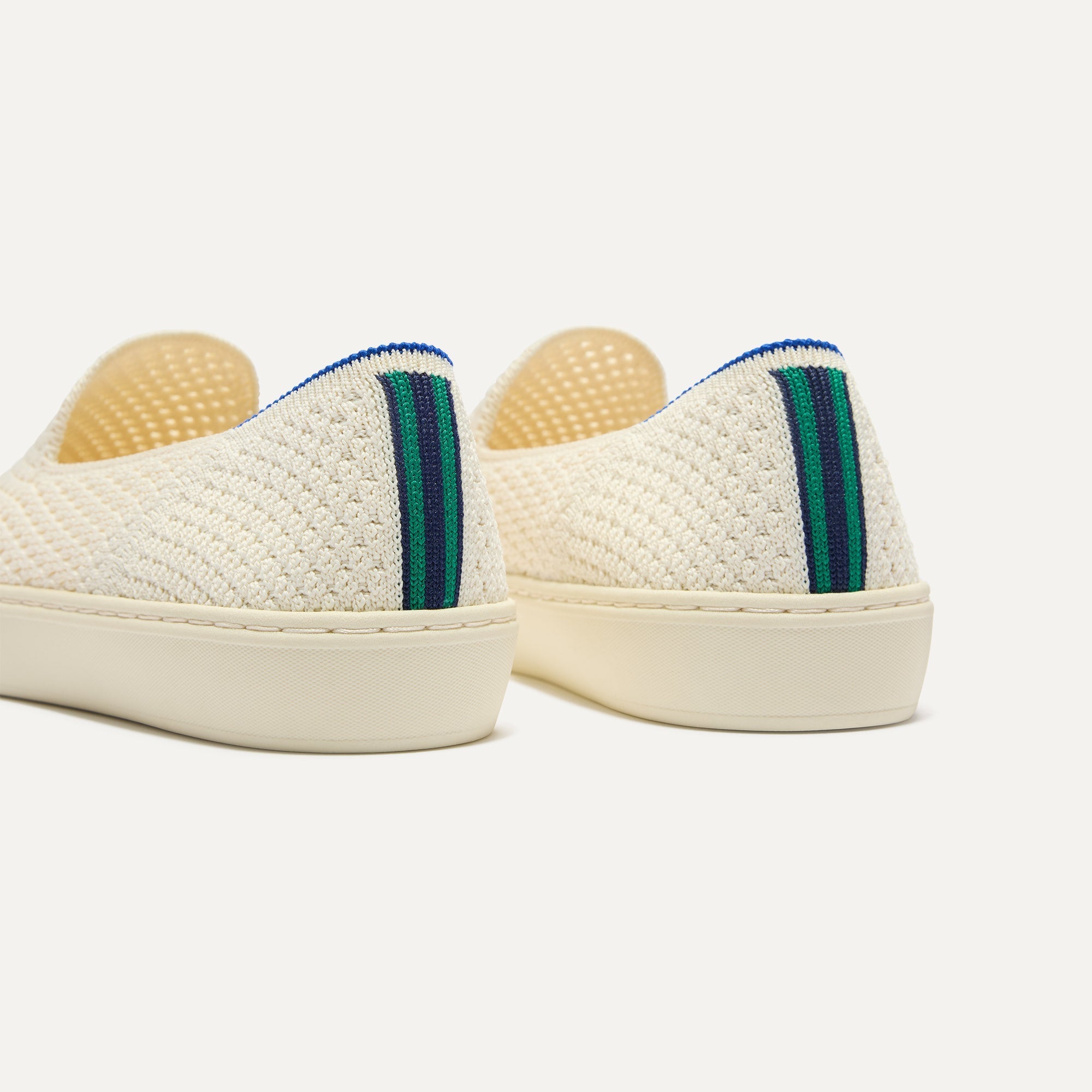 Close up of the heel of The Original Slip On Sneaker in Volley, with Rothy's signature blue halo. 