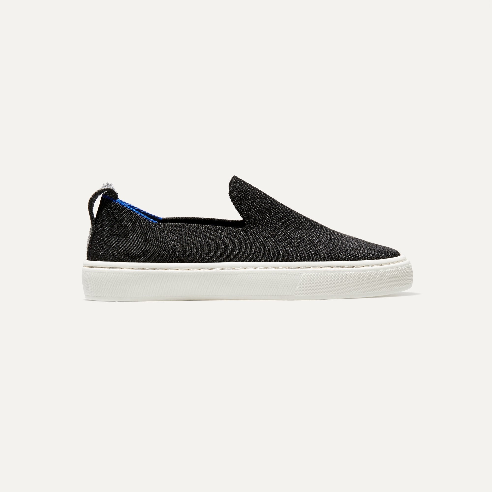 The Kids slip-on Sneaker in Black shown from a side view showing the outsole.