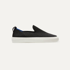 The Kids slip-on Sneaker in Black shown from a side view showing the outsole.
