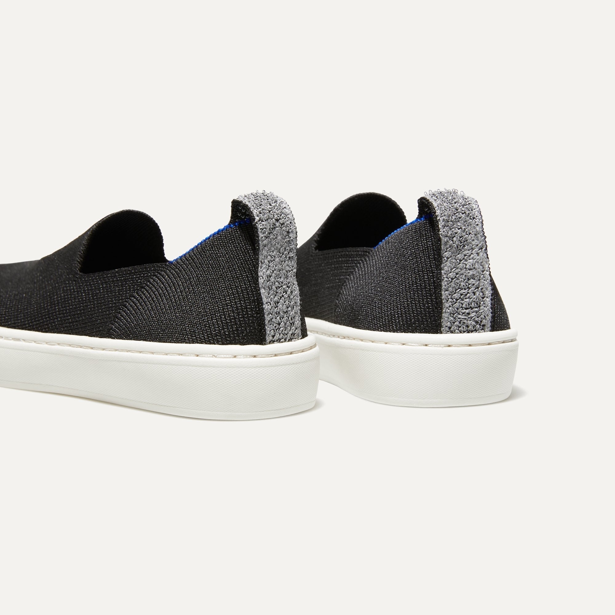 The Kids slip-on Sneaker in Black shown from the back view with the heel detail.