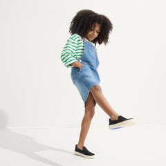 Alternate view of a model wearing The Kids Sneaker in Black.
