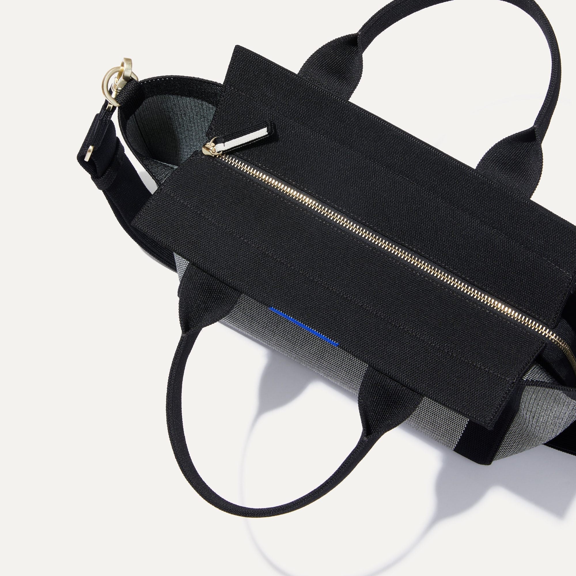 The Handbag in Grey Mist close up of Rothy’s halo detail and top handles.