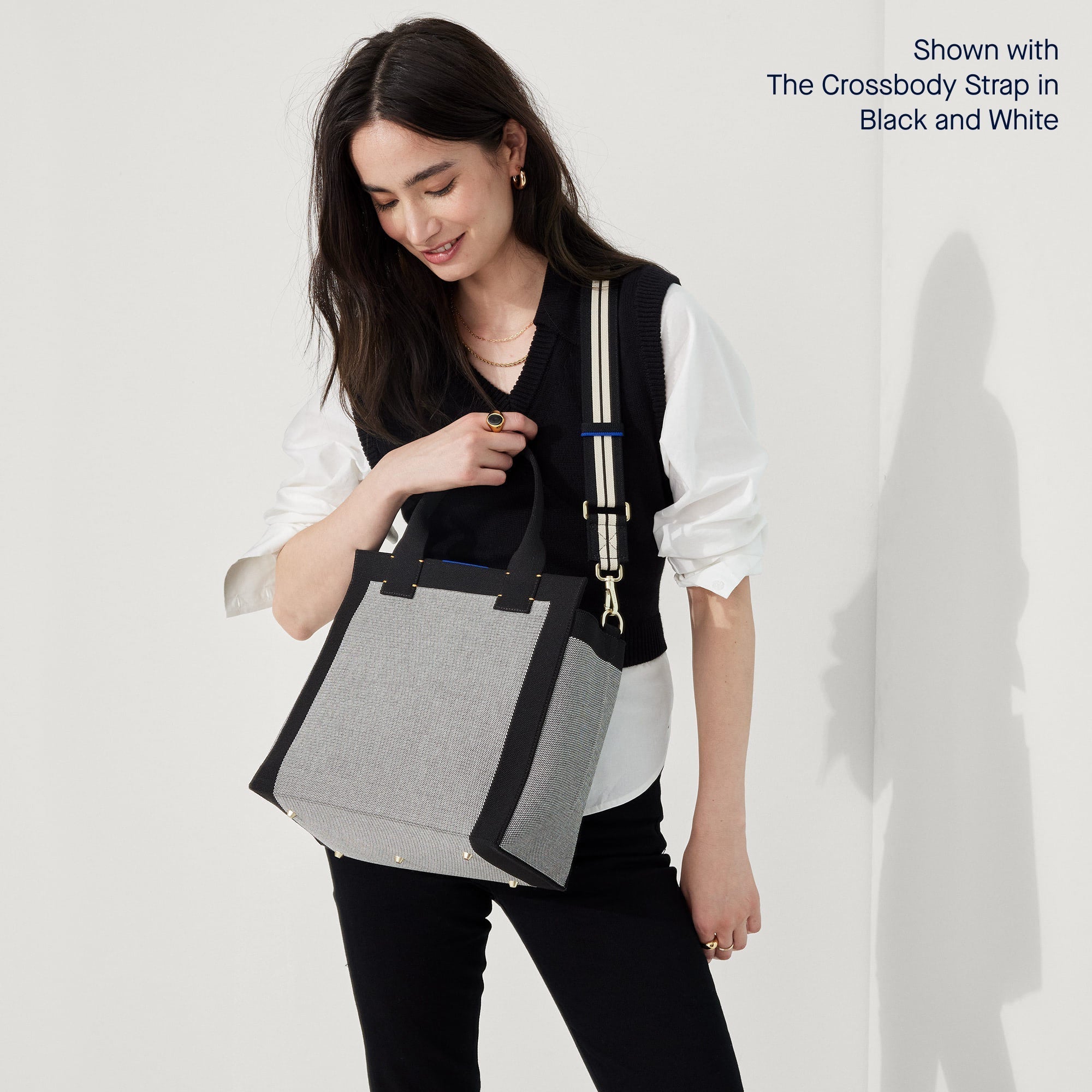 Model wearing The Handbag in Grey Mist shown paired with the Crossbody Strap in Black and White Stripe.
