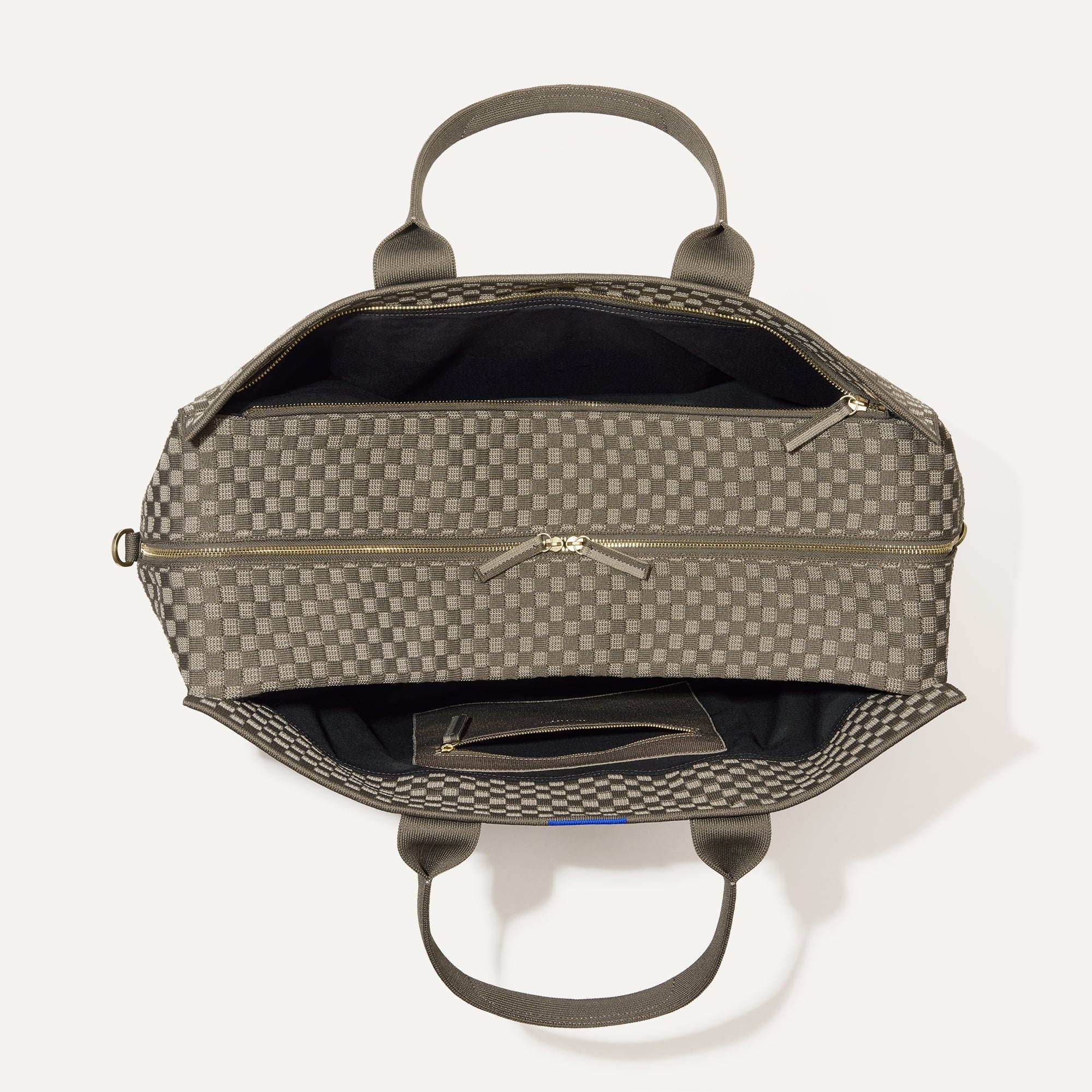 The Weekender in Safari Green shown from the top with zipper side compartment and magnetic side compartment open.