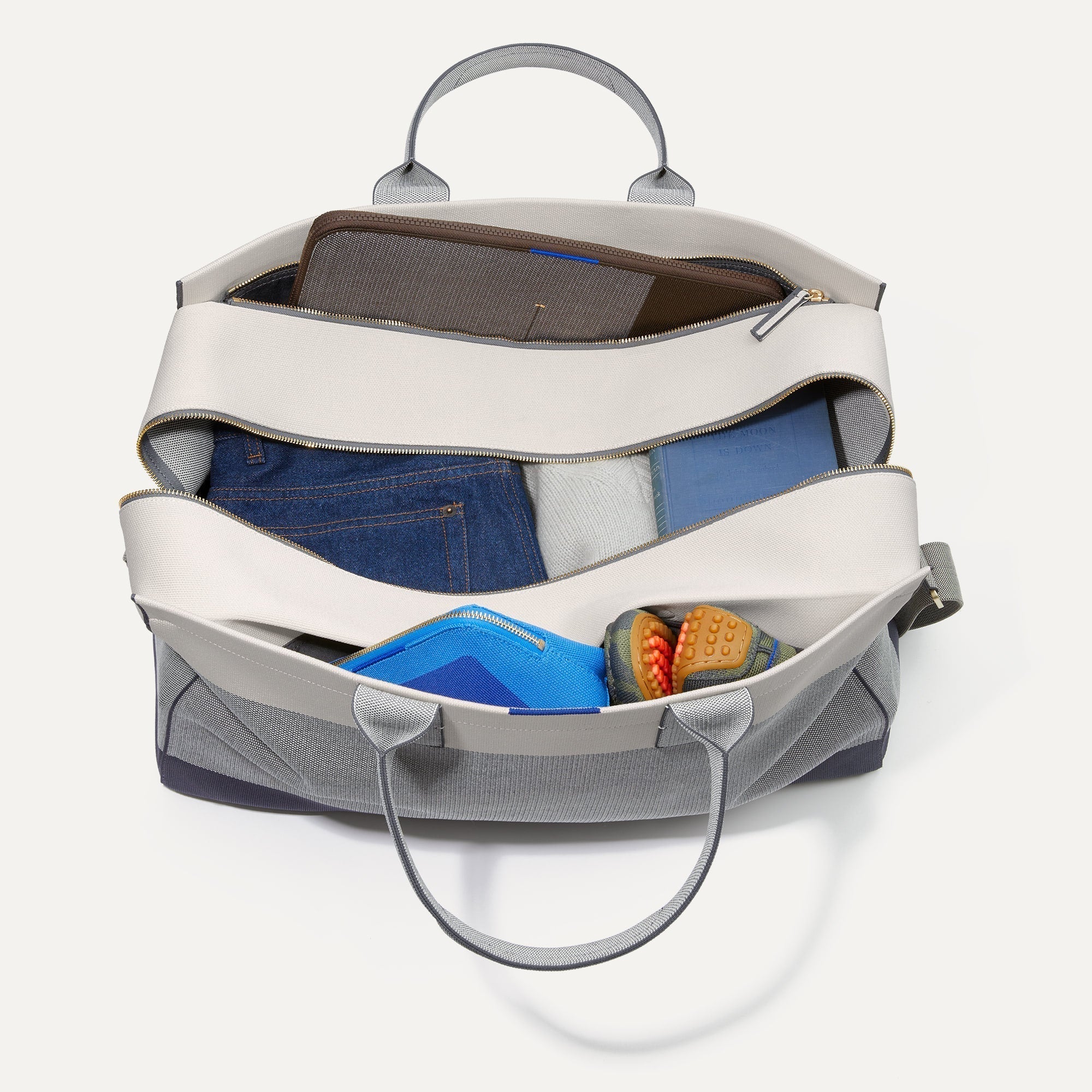 The Weekender shown from the top with zipper side compartment and magnetic side compartment open.