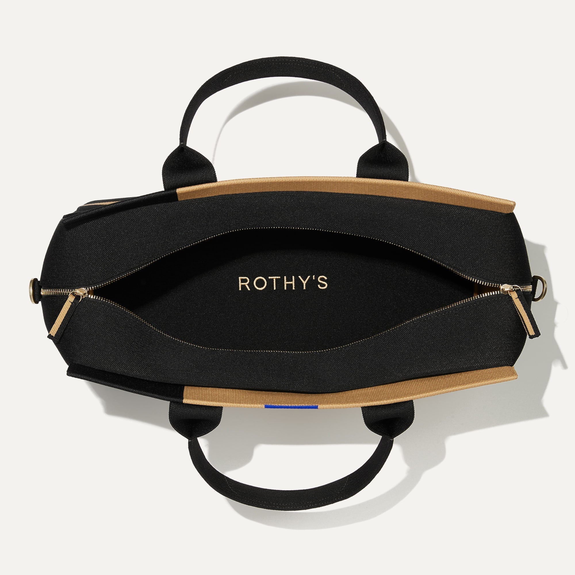 The Overnighter in Camel and Black shown open from the top.