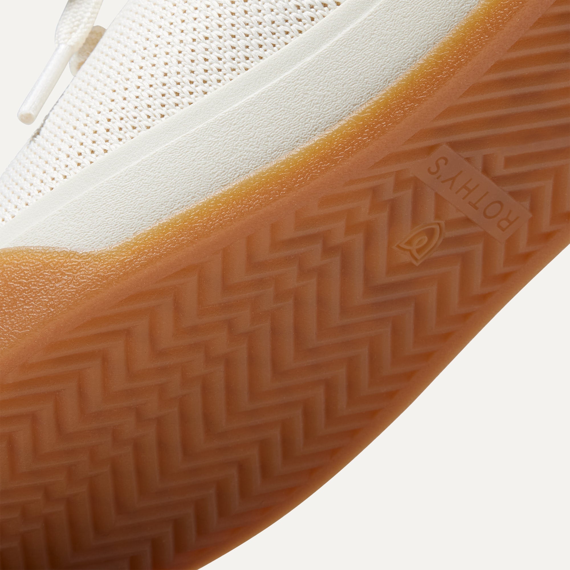 The sole of The Lace Up Sneaker in Blonde shown in diagonal view.