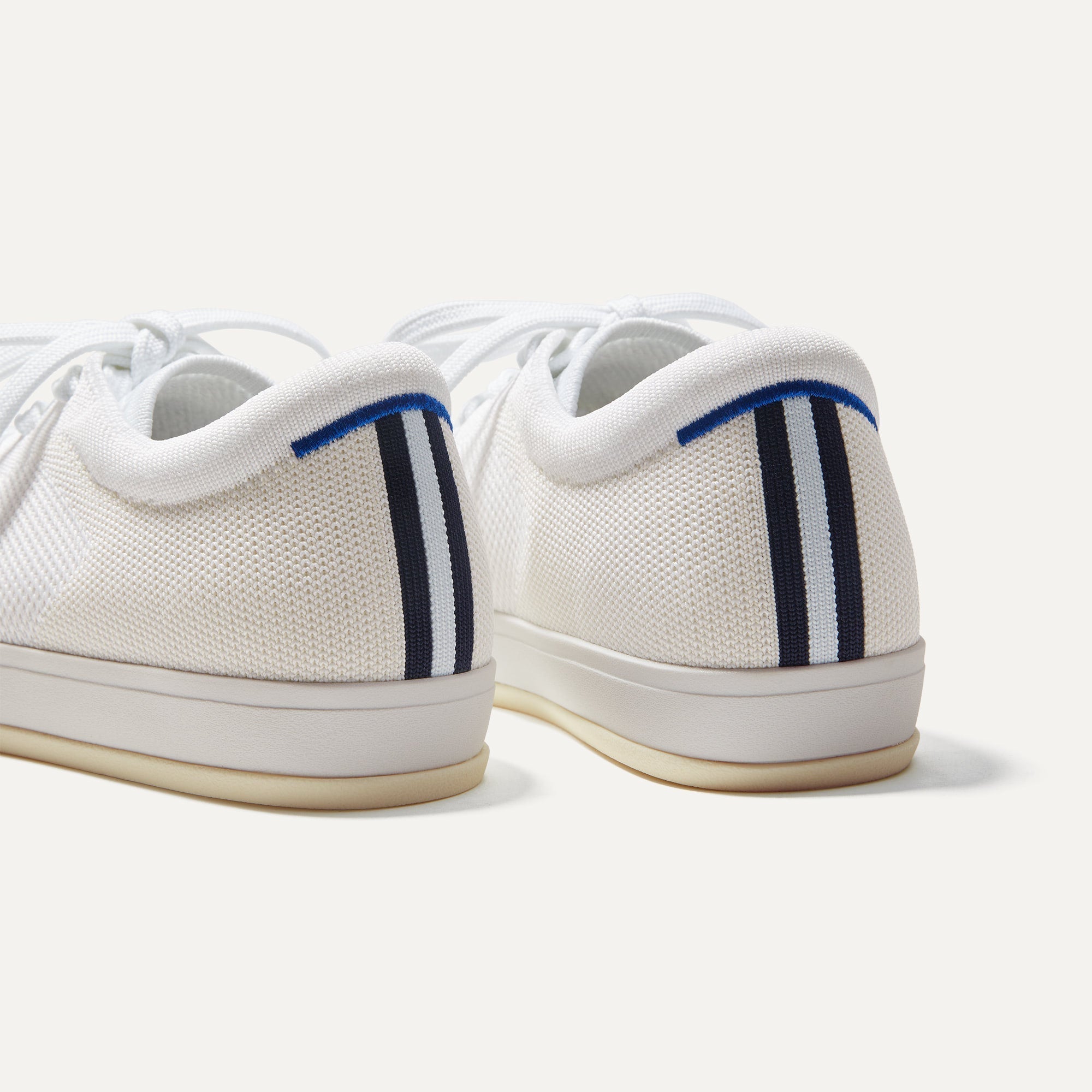 Close up of the heel of The Lace Up in Bright White, with the padded ankle collar and Rothy's signature blue halo. 