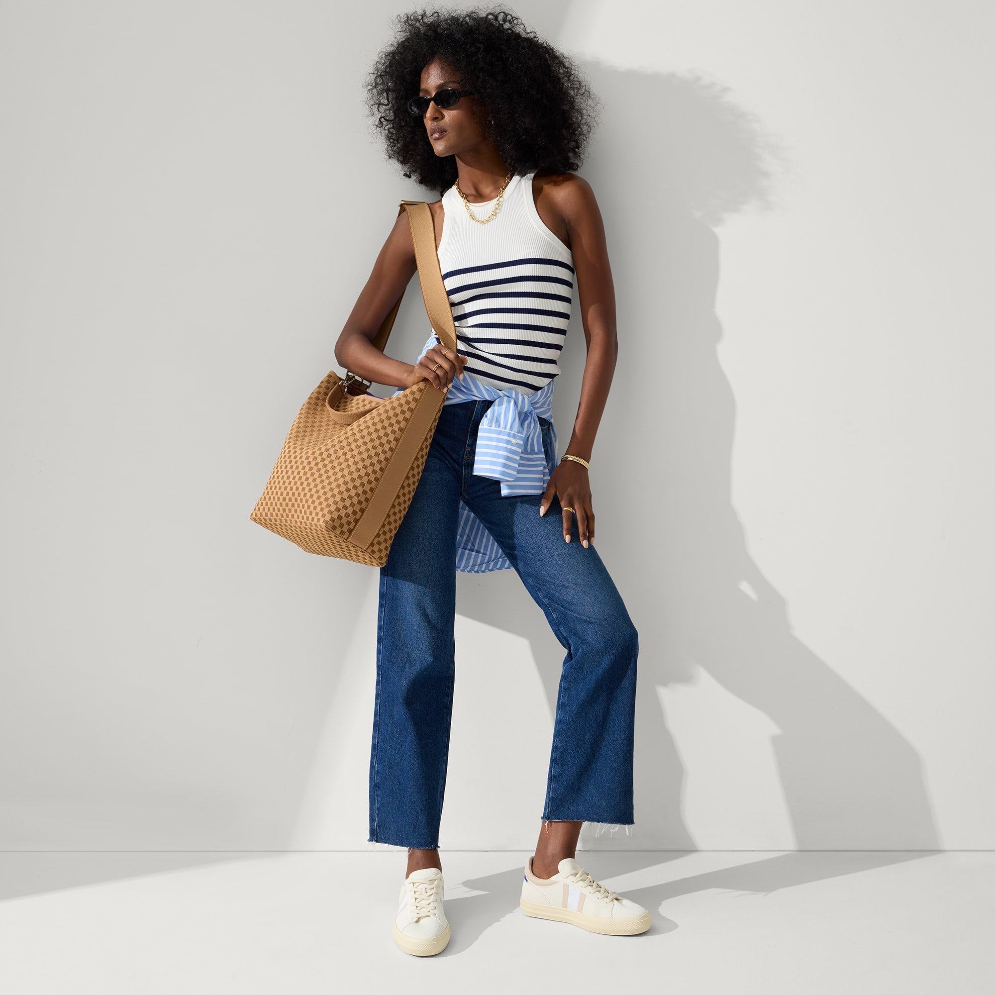 The Bucket Bag in Hazelnut shown worn differently on model.