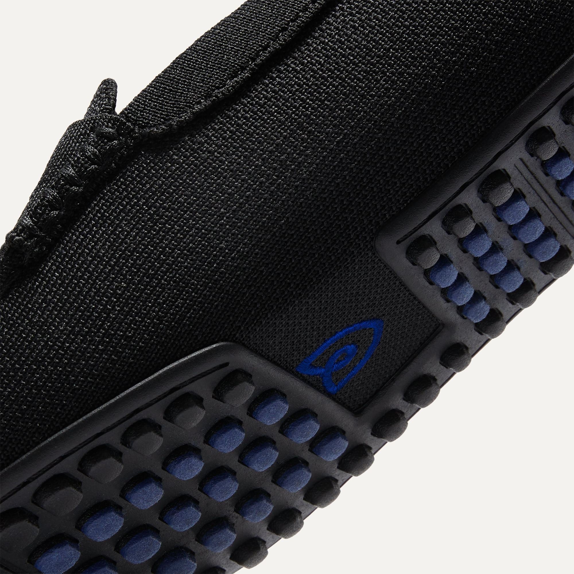 Close up of the outsoles of The Driving Loafer in Black, with raised nub details and the Rothy's signet on the base of the shoe.