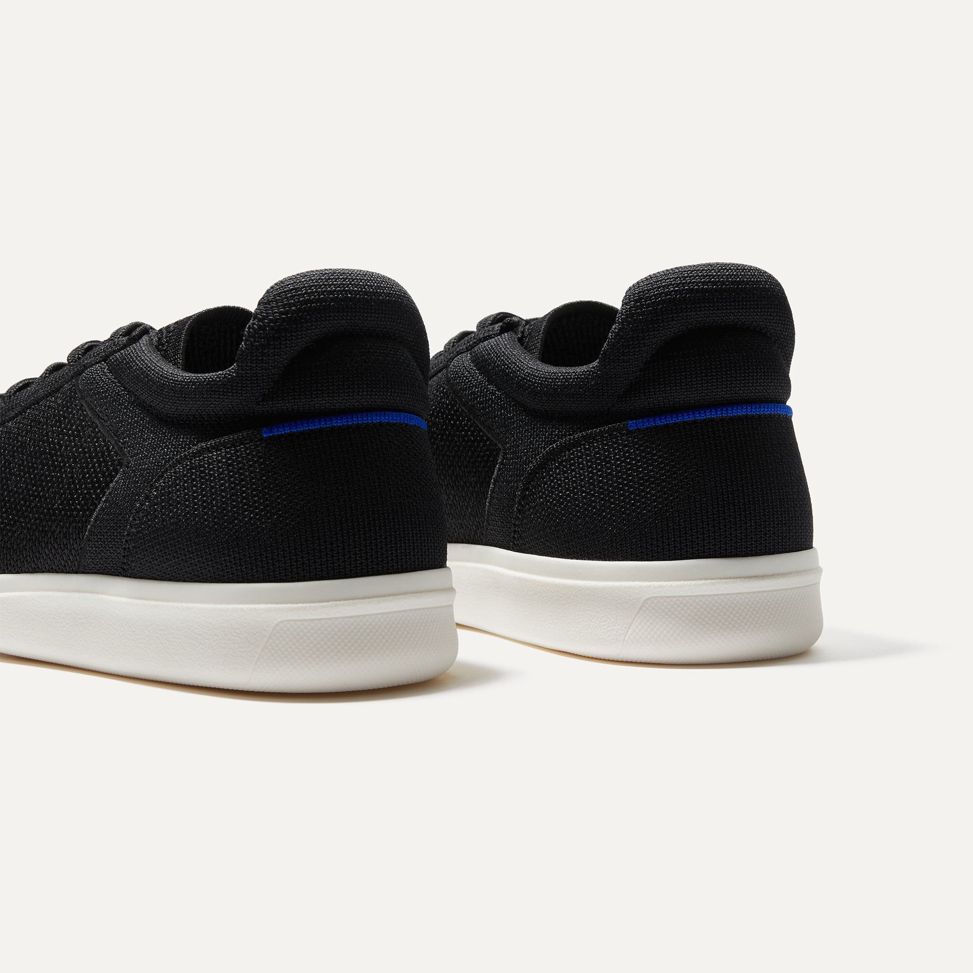 Close up of the heel of The RS01 Sneaker in Black, with the padded ankle collar and Rothy's signature blue halo.