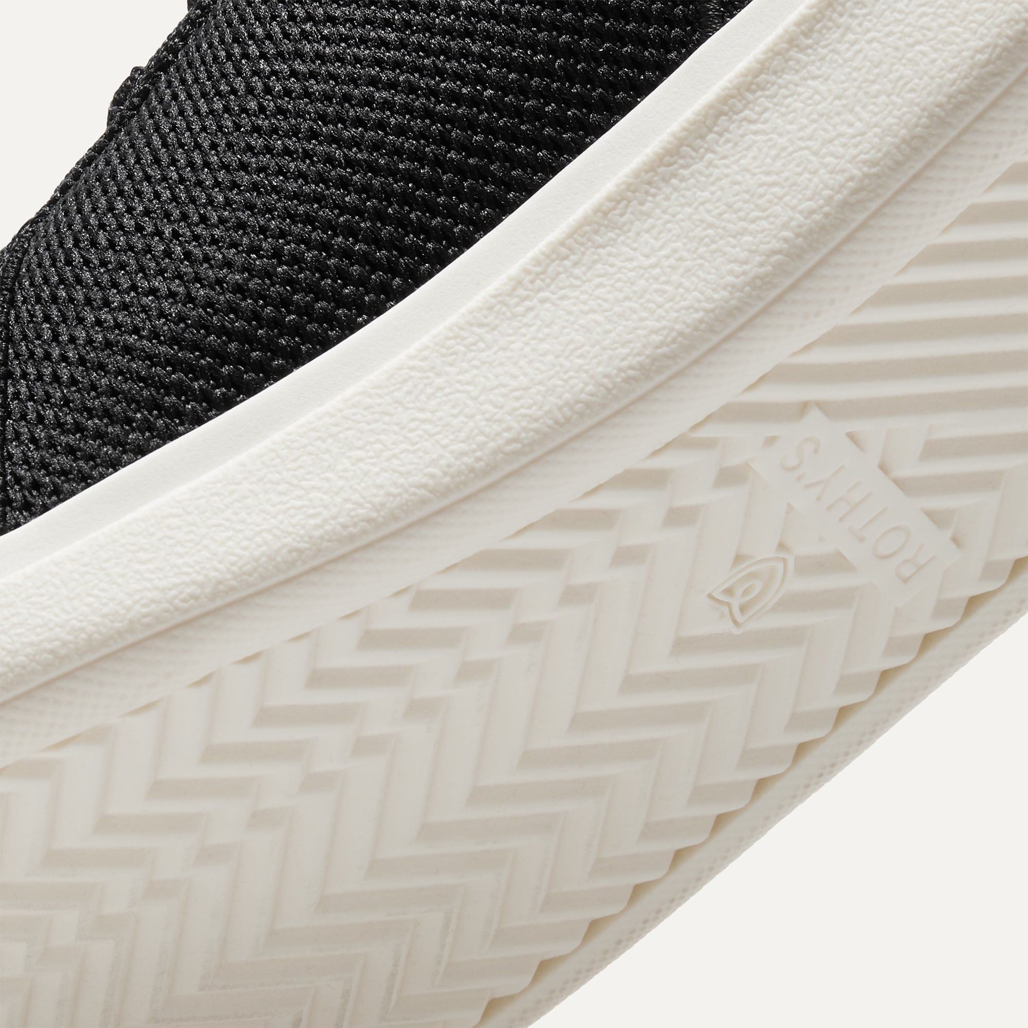 Close up of the outsoles of The RS01 Sneaker in Black, with raised grooves for added traction.