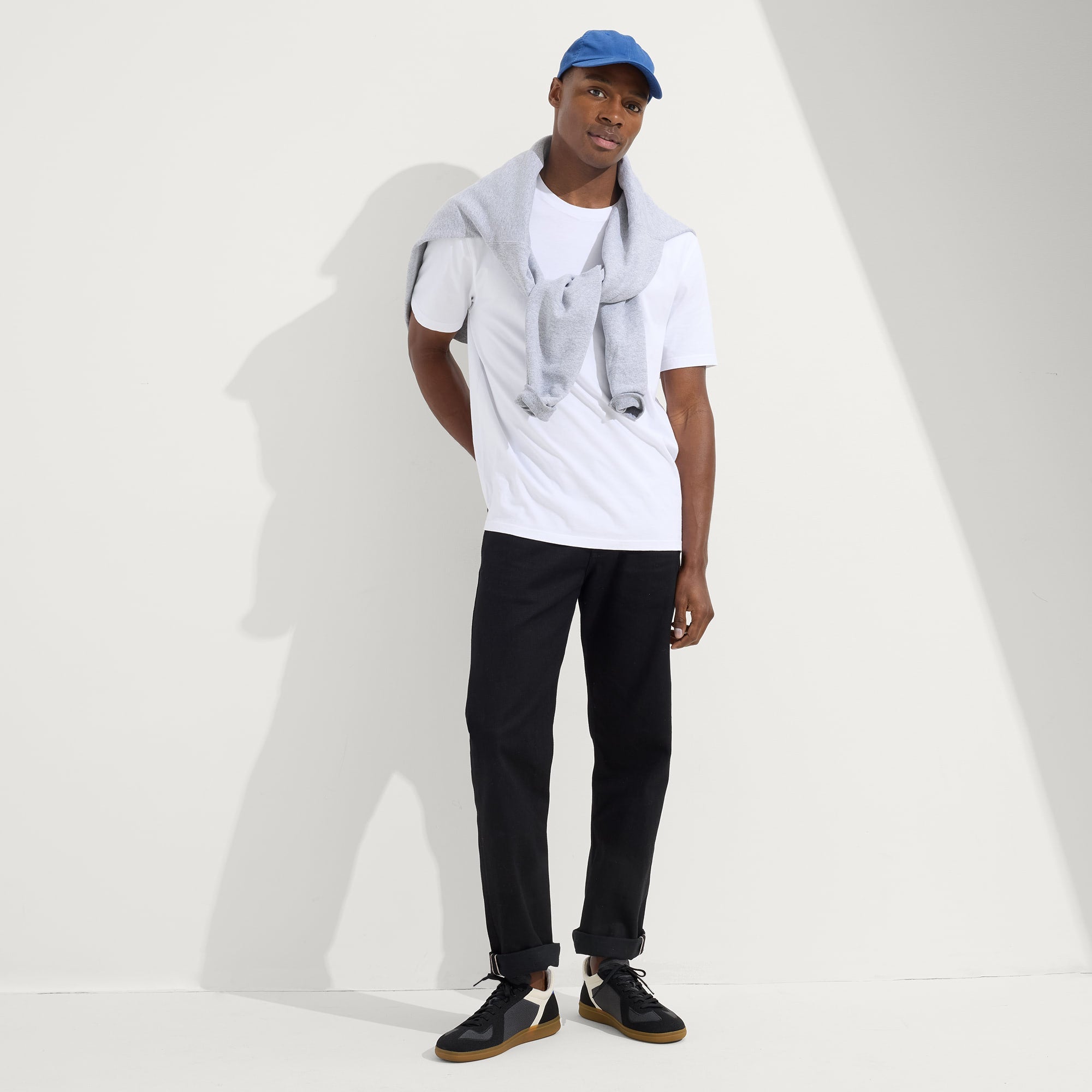 Alternate view of a model wearing The RS01 Sneaker in Obsidian Black.