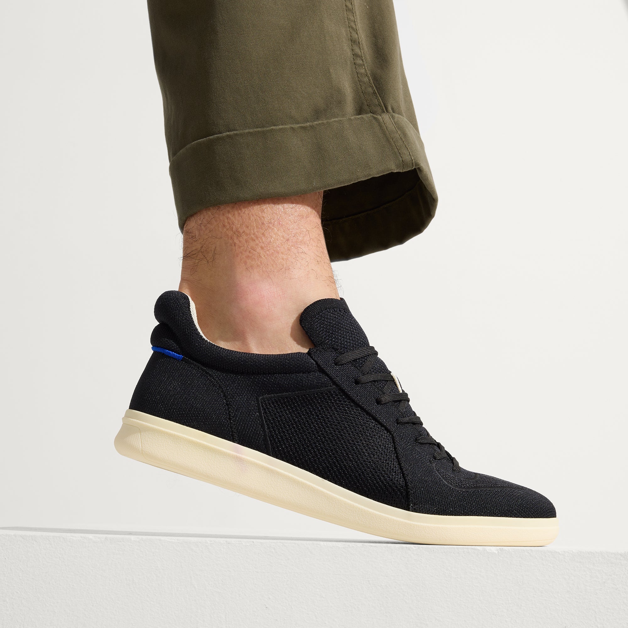 hover | Model wearing The RS01 Sneaker in Black.