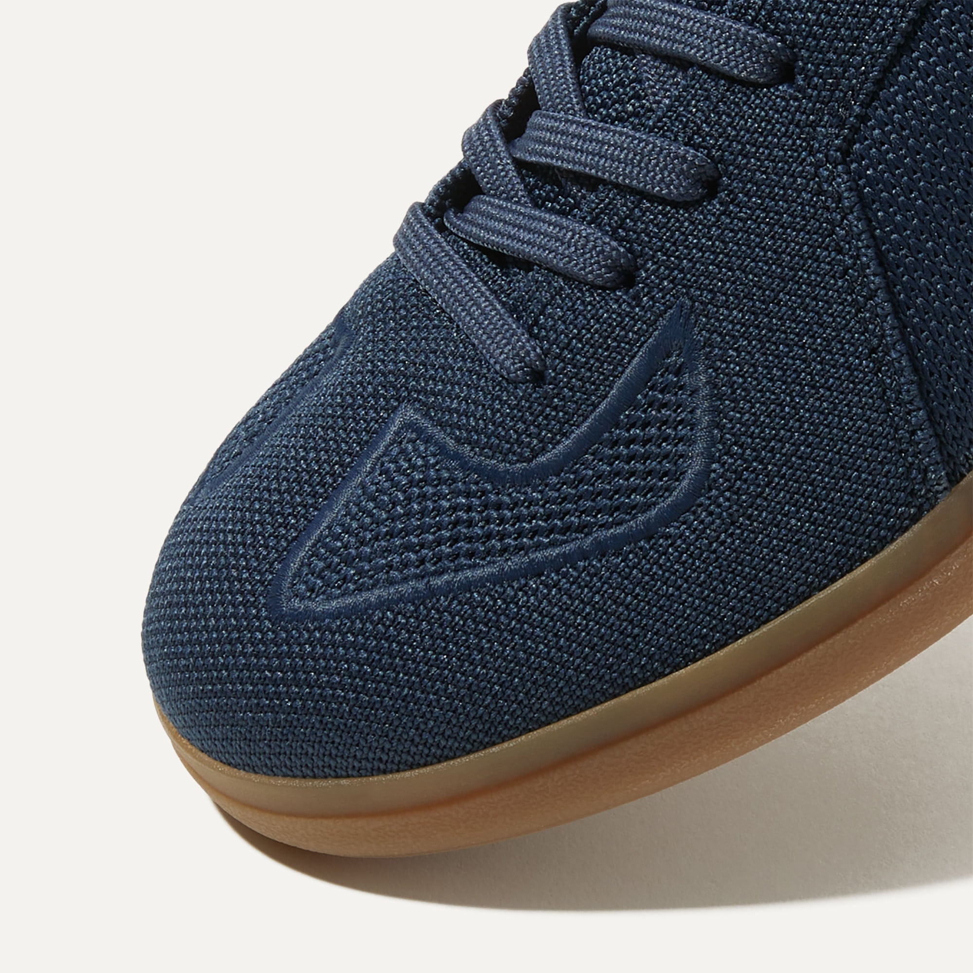 Close up of the toe and stitching details of The RS01 Sneaker in Navy.