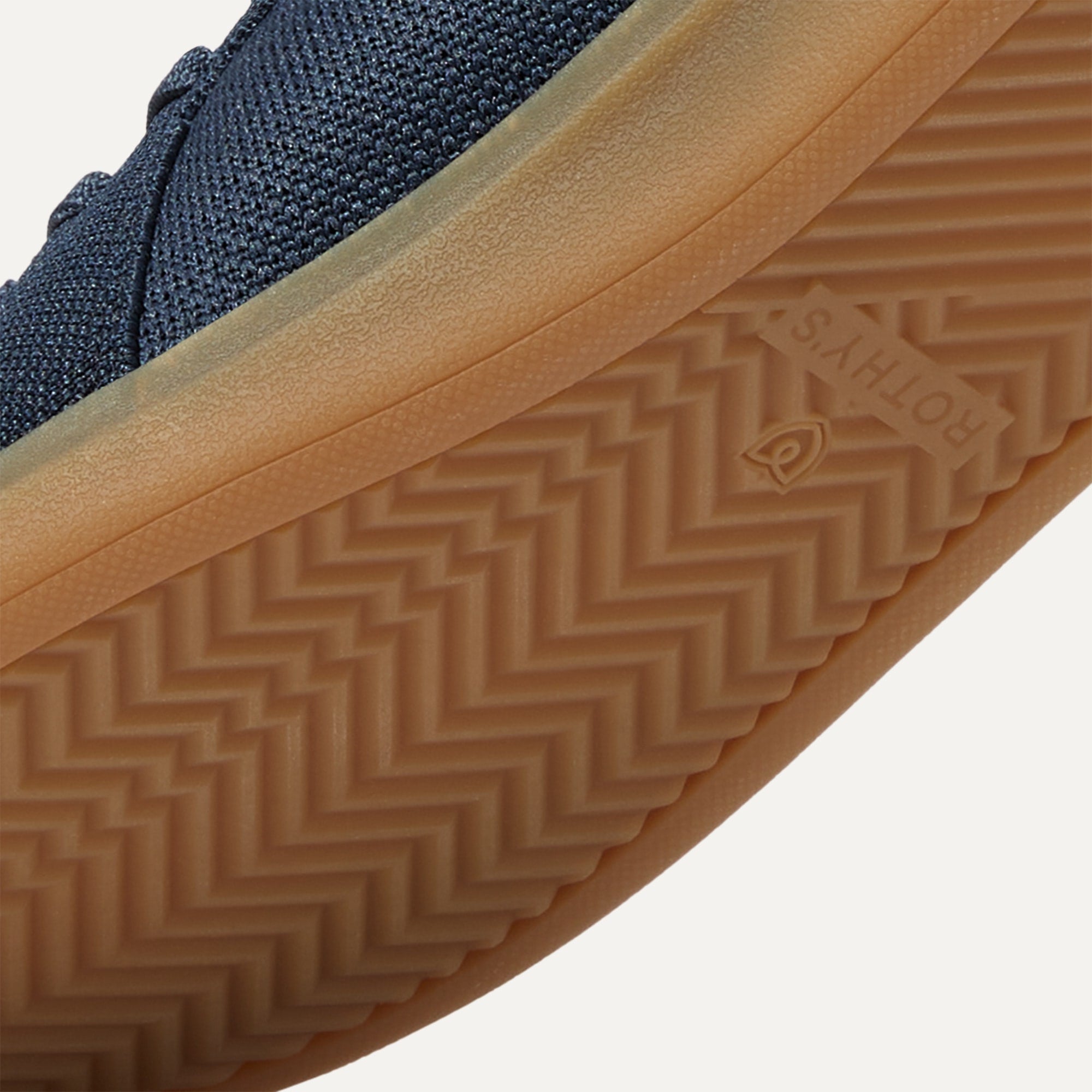 Close up of the outsoles of The RS01 Sneaker in Navy, with raised grooves for added traction.