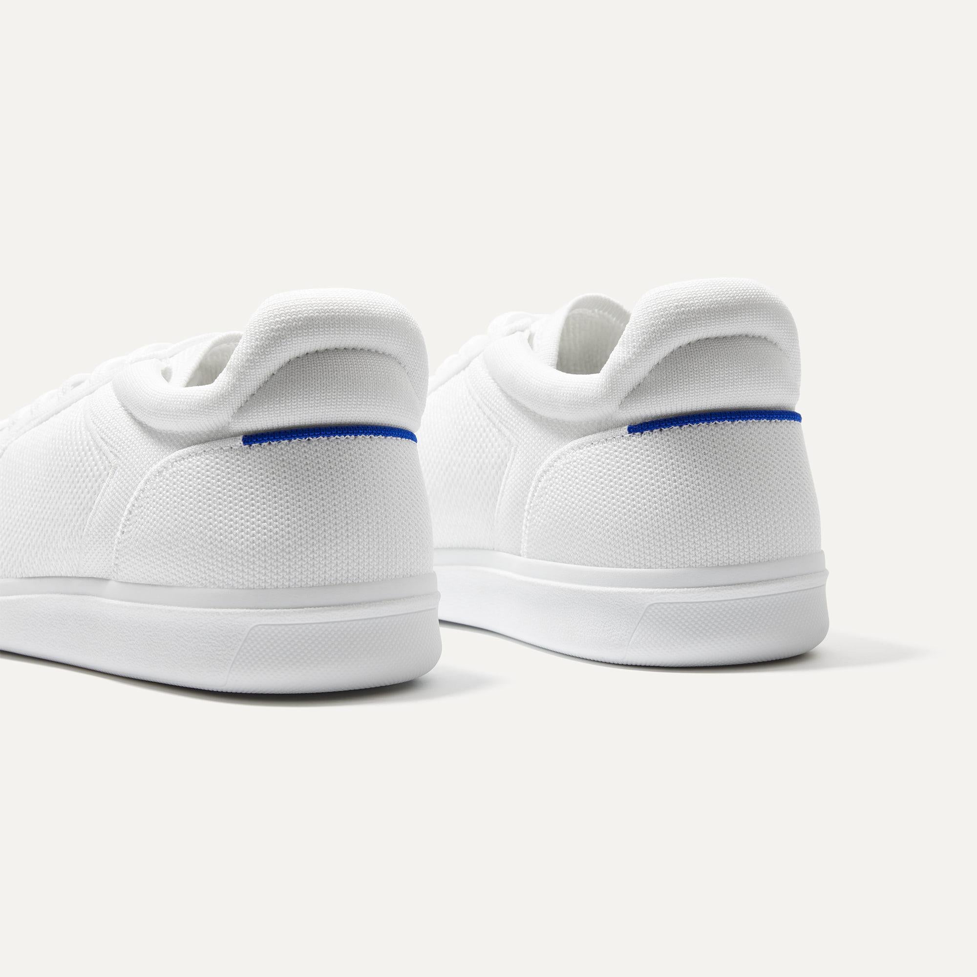 Close up of the heel of The RS01 Sneaker in White, with the padded ankle collar and Rothy's signature blue halo.