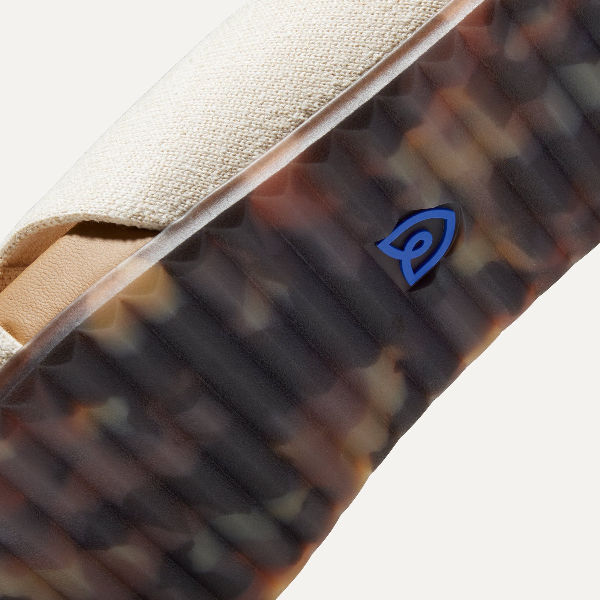 Close up of the outsole of The Weekend Slide in Oat, shown in a diagonal view. 