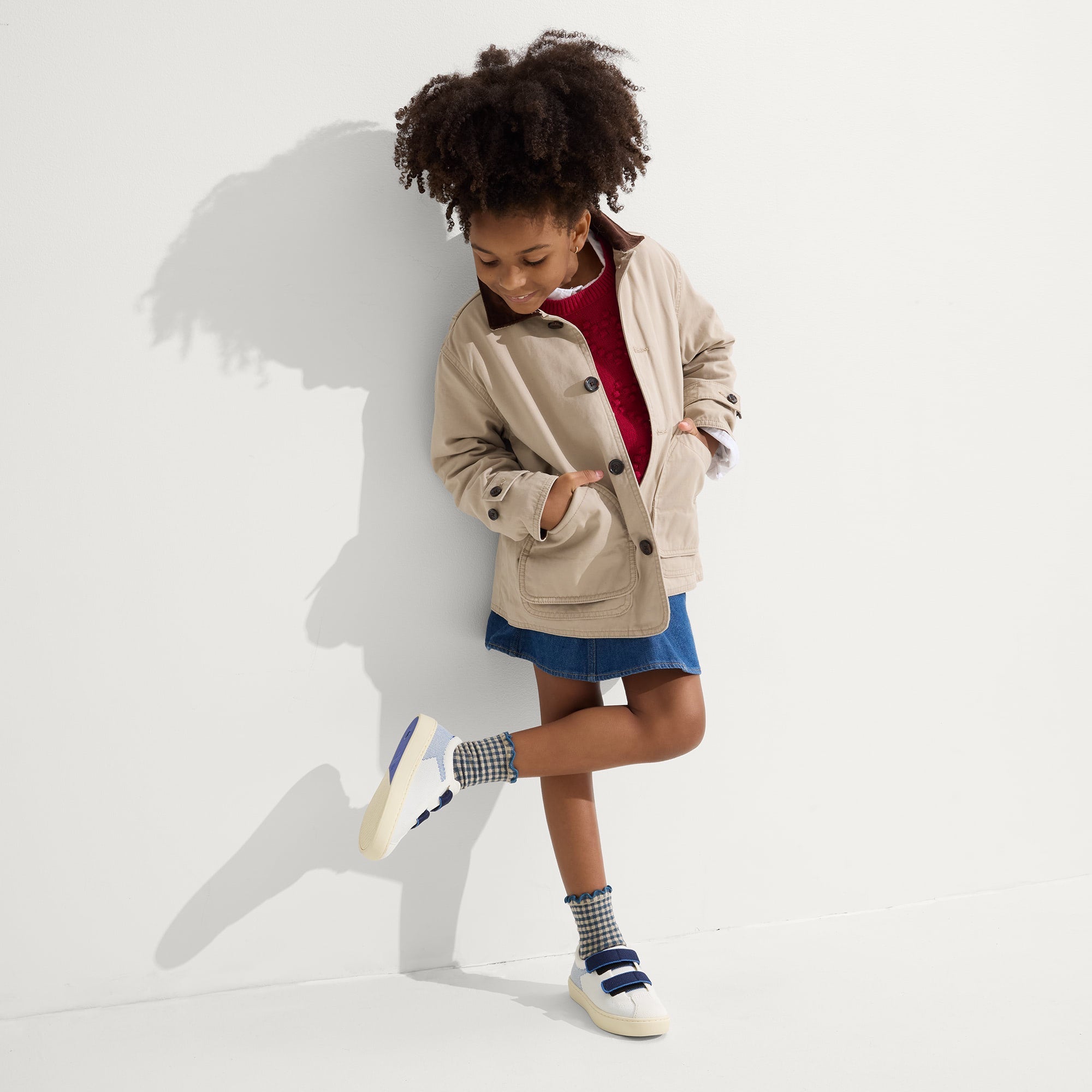A child modeling The Kids Strap Sneaker in Blue Raspberry.