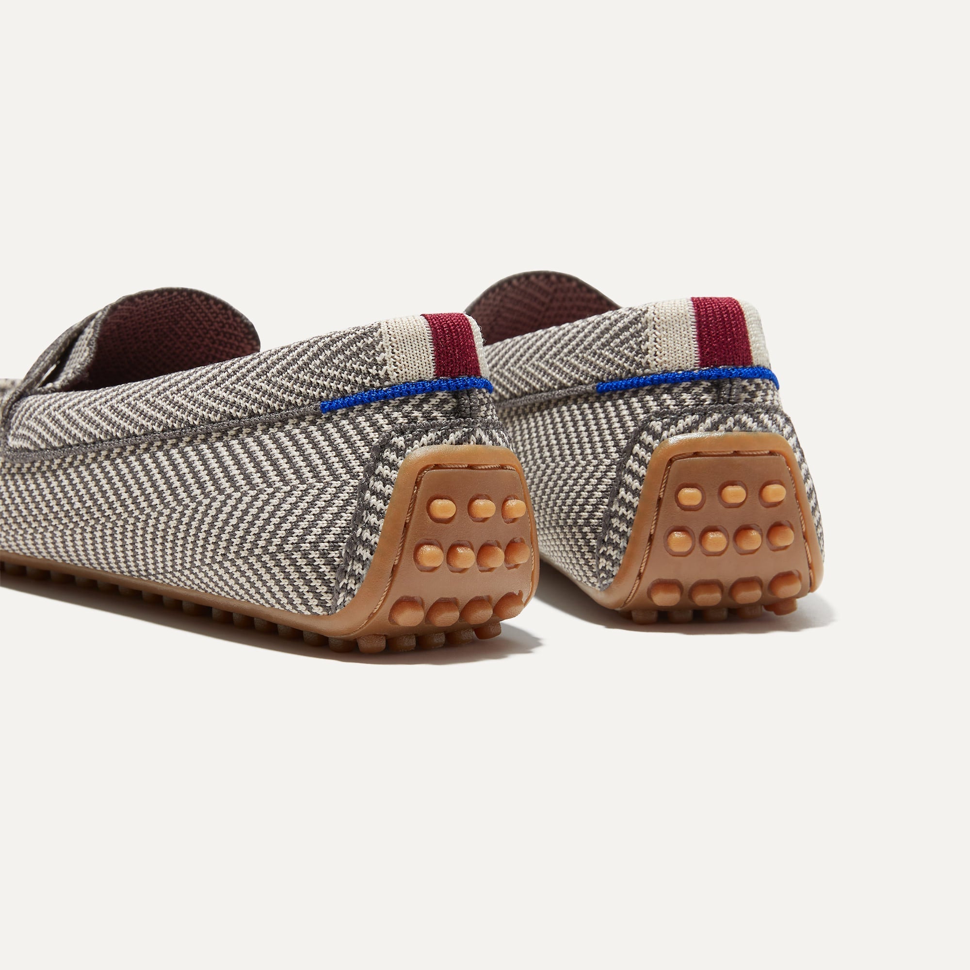 Close up of the heel of The Driver in Iron Herringbone, with raised nub outsoles and Rothy's signature blue halo.