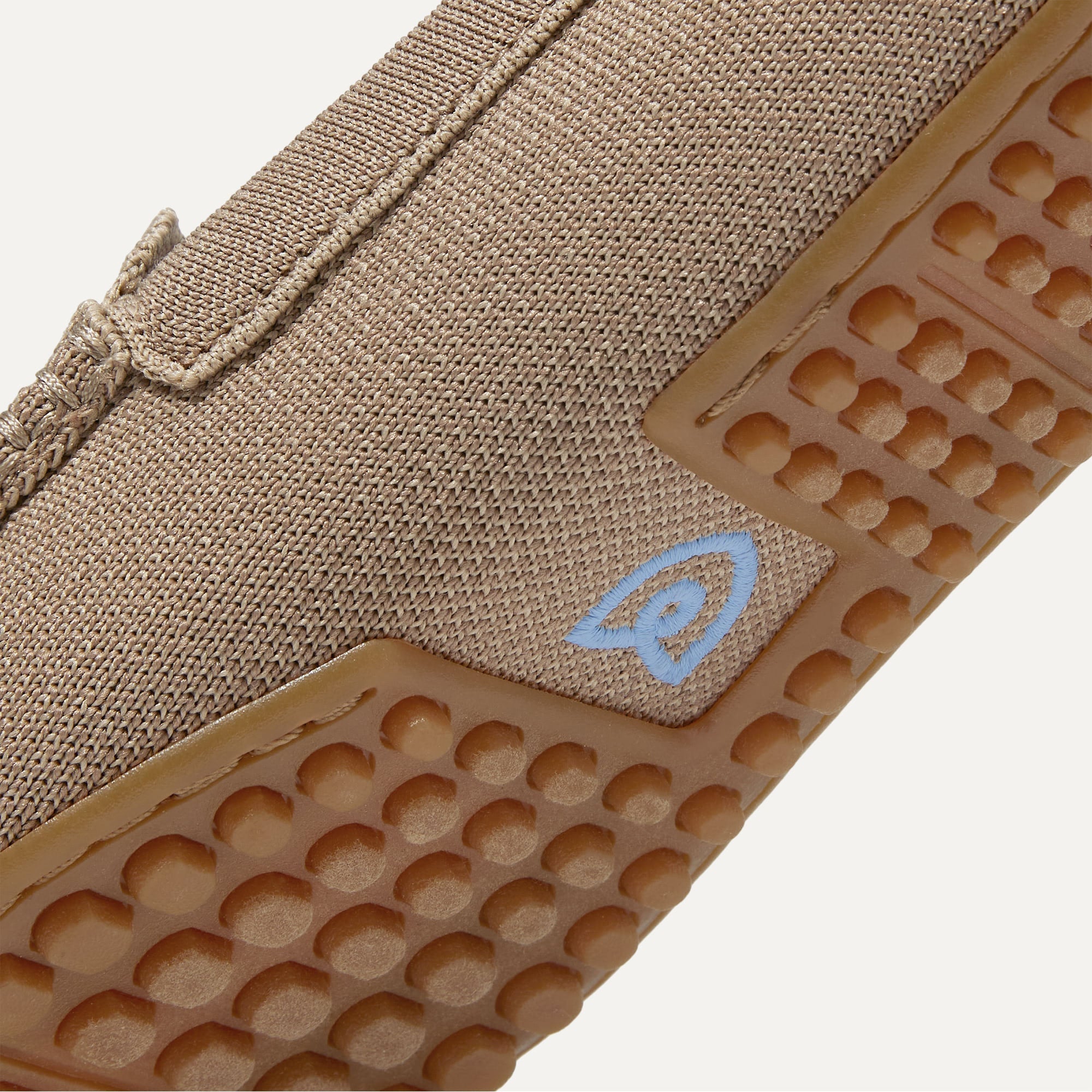 Close up of the raised nub outsoles of The Driver in Latte.