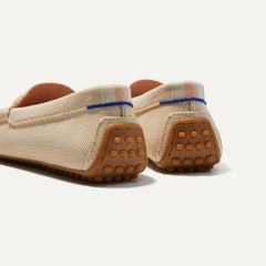 Close up of the heel of The Driver in Sesame, with raised nub outsoles and Rothy's signature blue halo. 