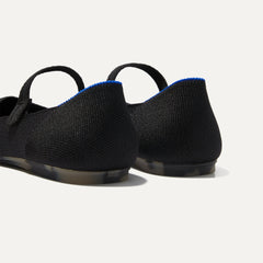 Close up of the heel of The Square Mary Jane in Black, with Rothy's signature blue halo. 