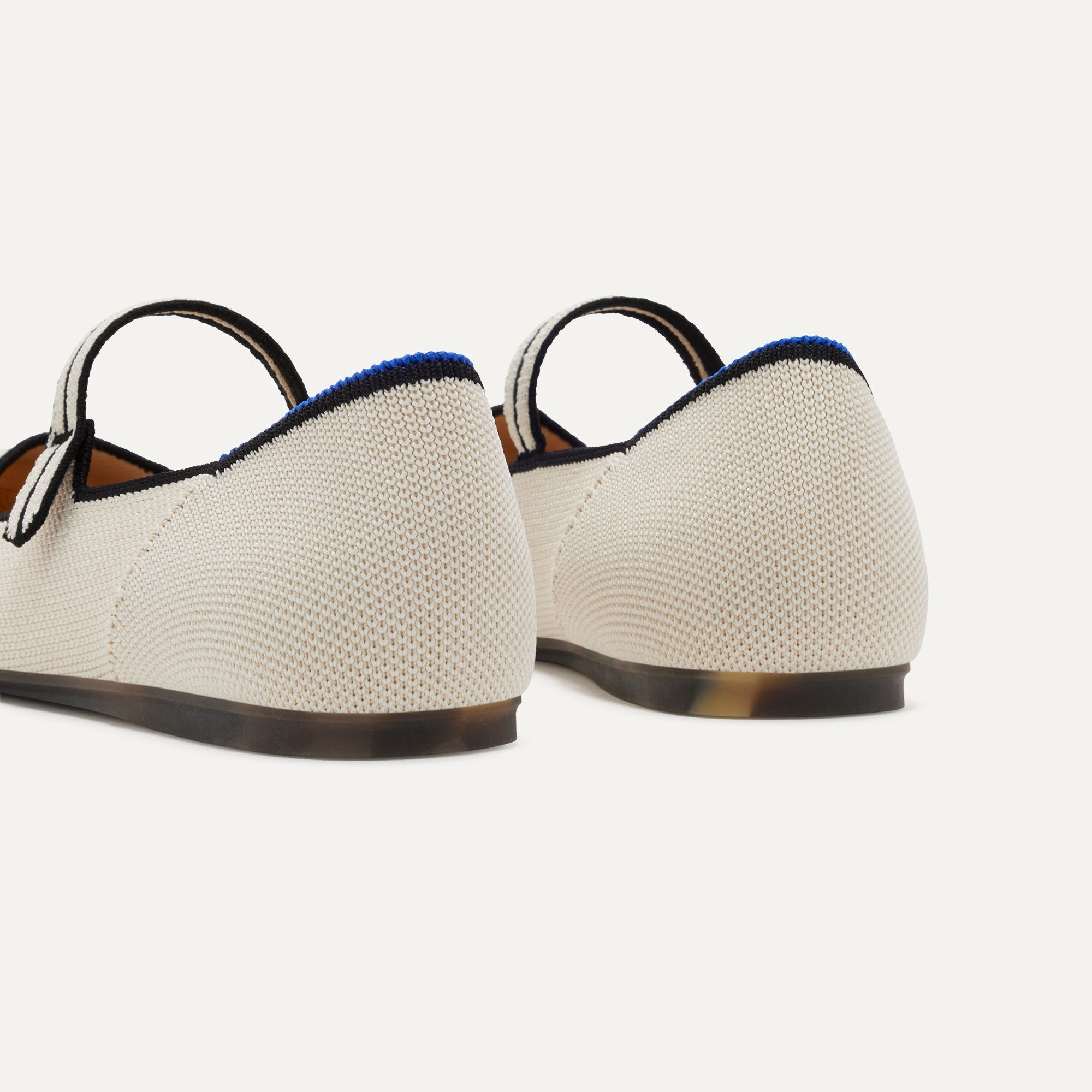 Close up of the heel of The Square Mary Jane in Gardenia, with Rothy's signature blue halo. 