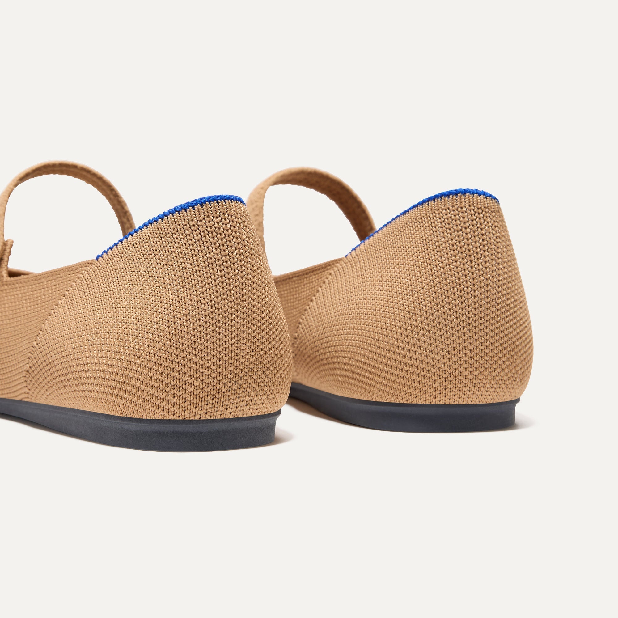 Close up of the heel of The Square Mary Jane in Wren Captoe, with Rothy's signature blue halo. 