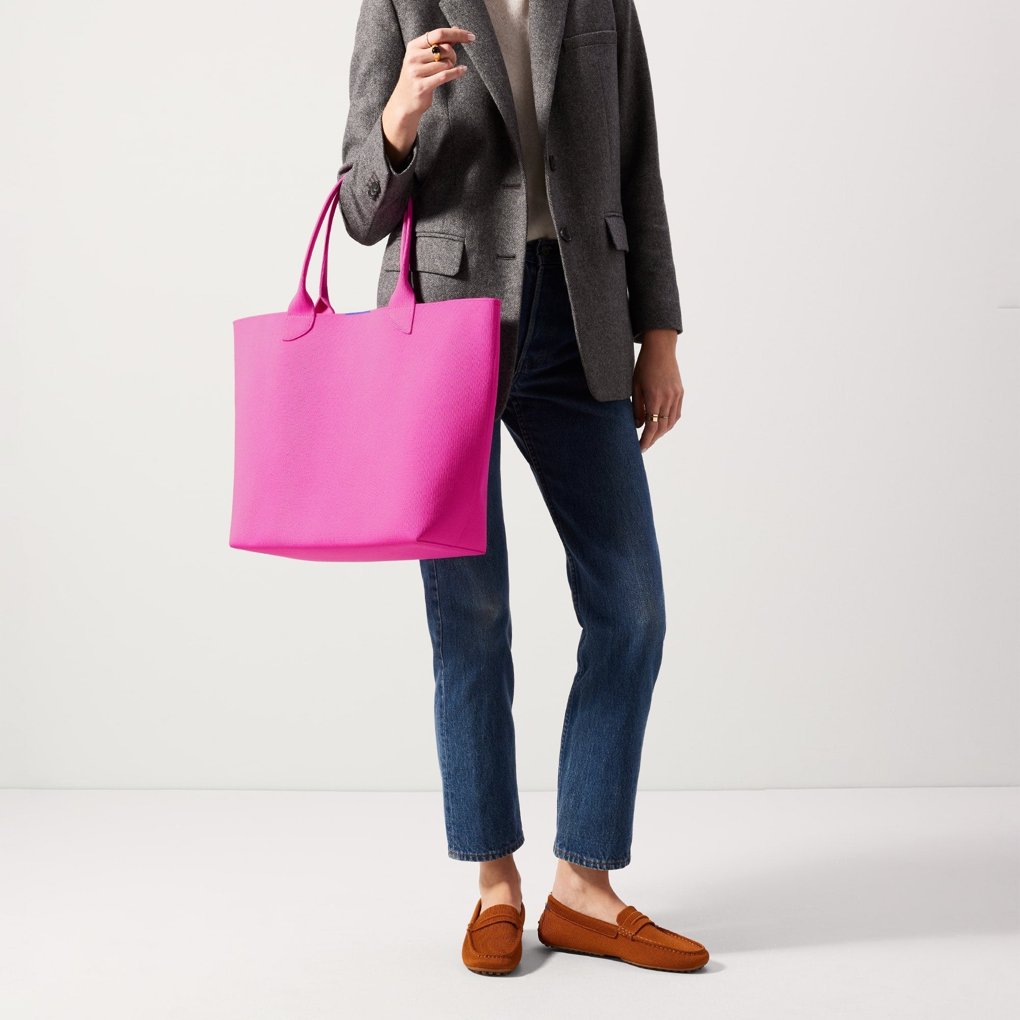 An alternate view of model holding The Lightweight Tote in Dragon Fruit.