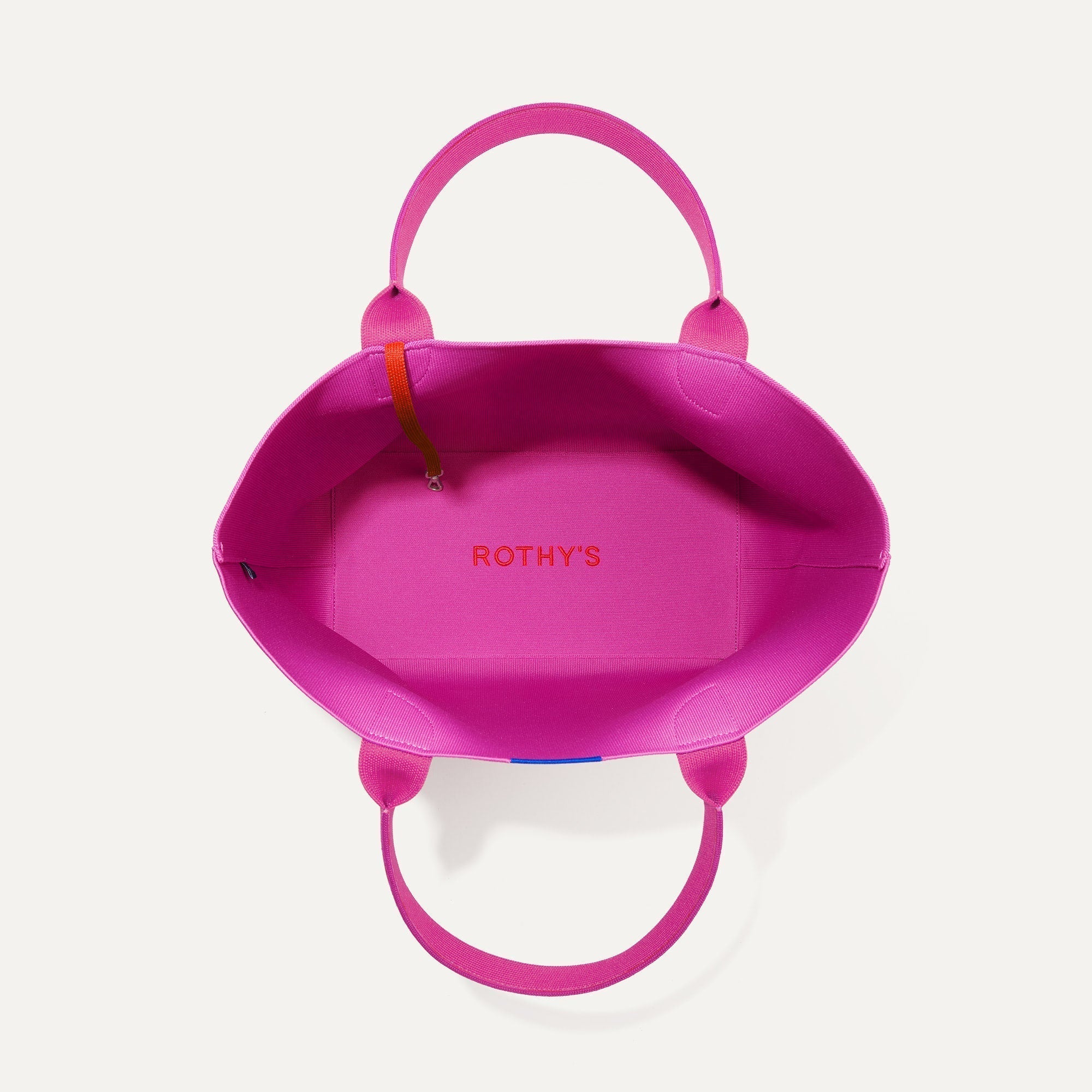 The Lightweight Tote in Dragon Fruit shown open from the top, with base insert visible. 