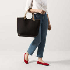 An alternate view of model holding The Lightweight Tote in Black Portobello.