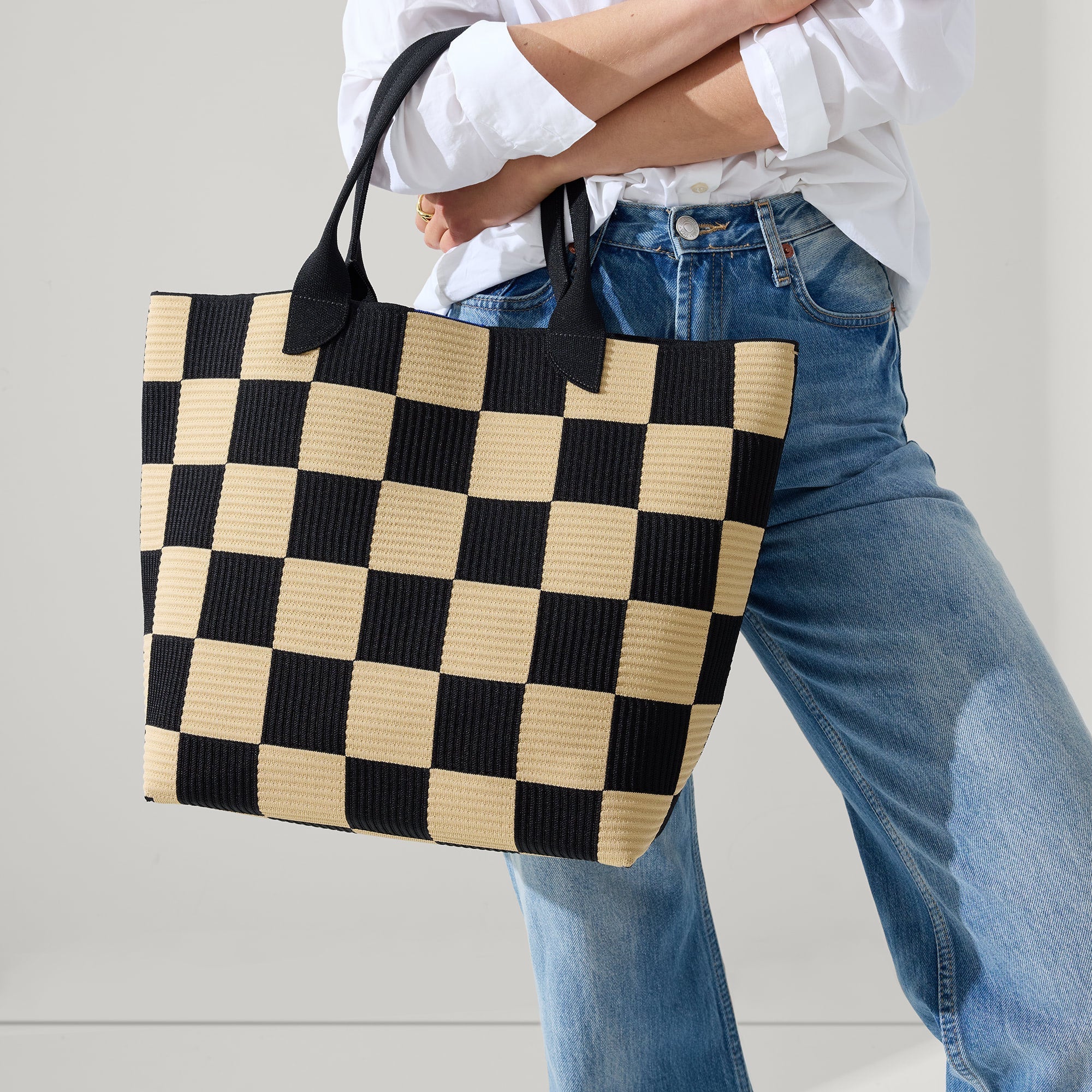 hover | Model holding The Lightweight Tote in Checker Classic.