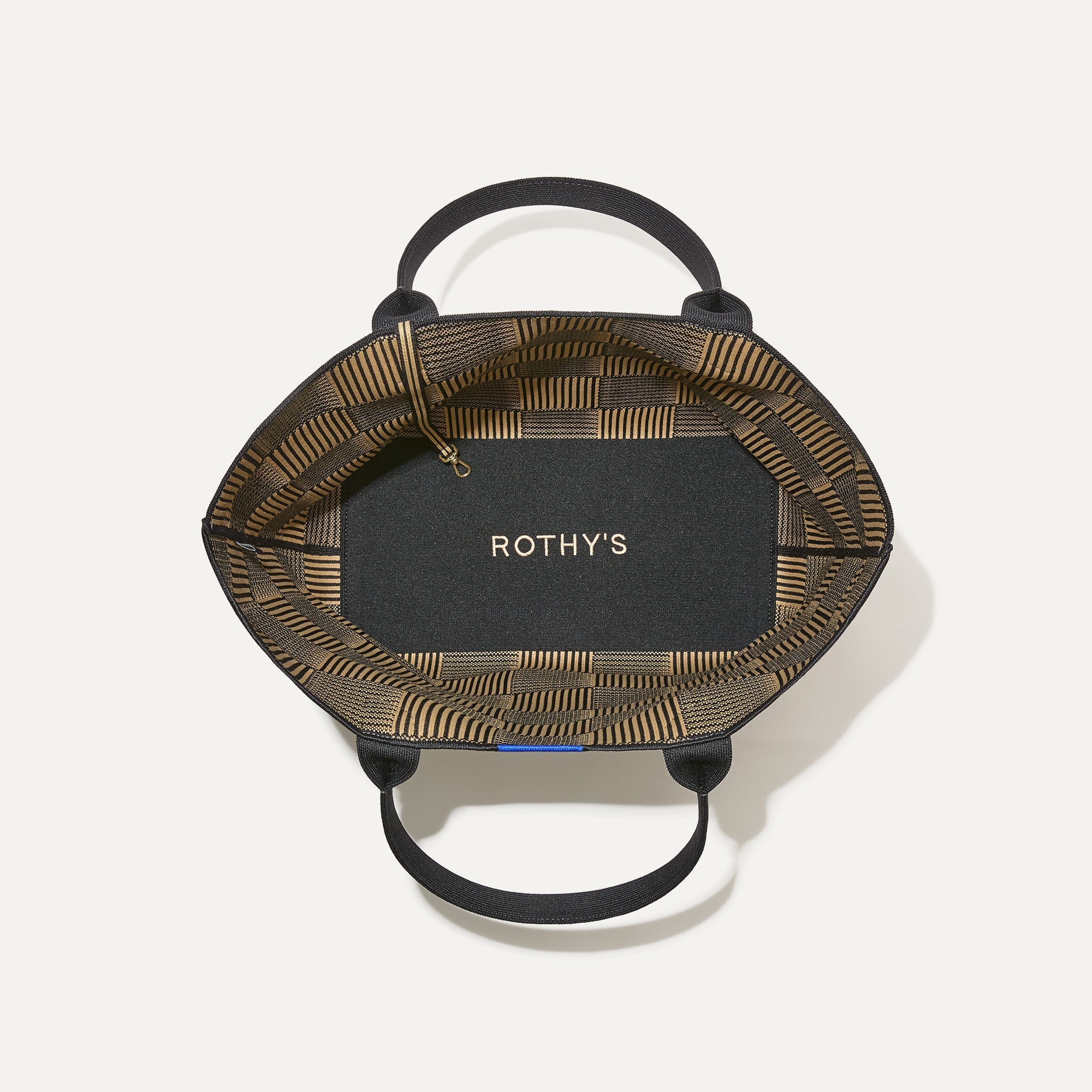 The Lightweight Tote in Checker Classic shown open from the top, with base insert visible. 