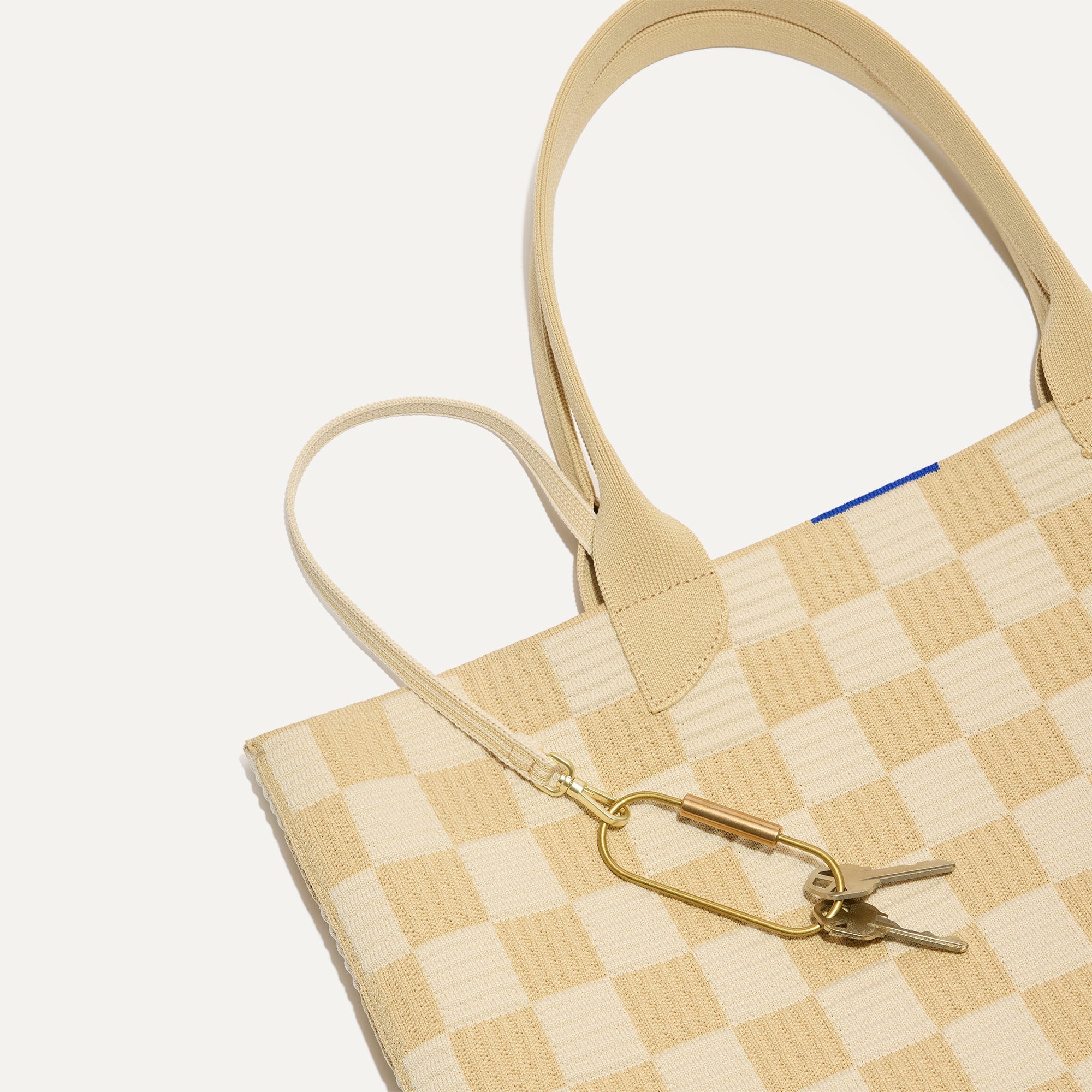 Close up of the handles and key leash detail of The Lightweight Tote in Checker Sand.