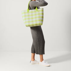 An alternate view of model holding The Lightweight Tote in Citrus Gingham.