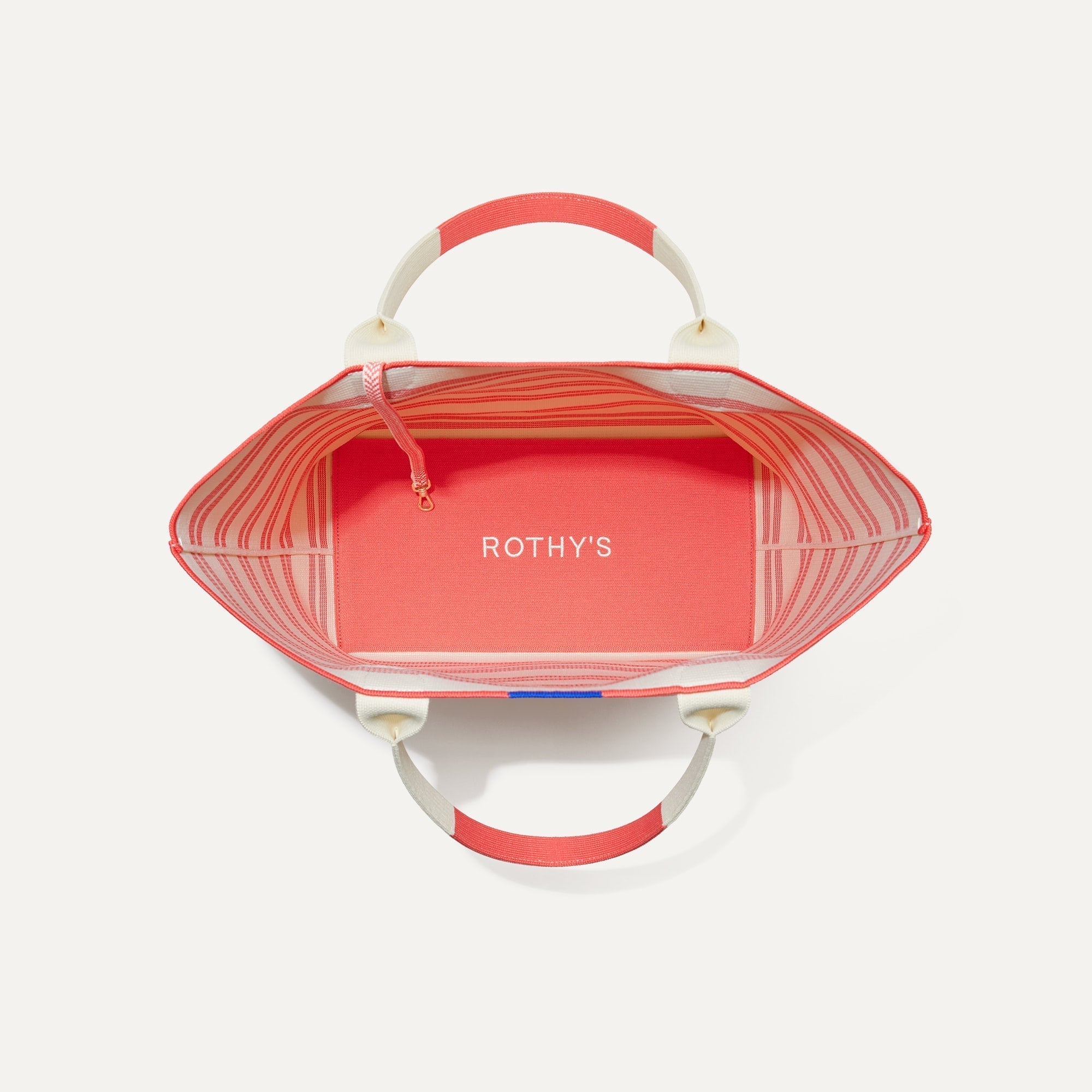 The Lightweight Tote in Coral Stripe shown open from the top, with base insert visible.
