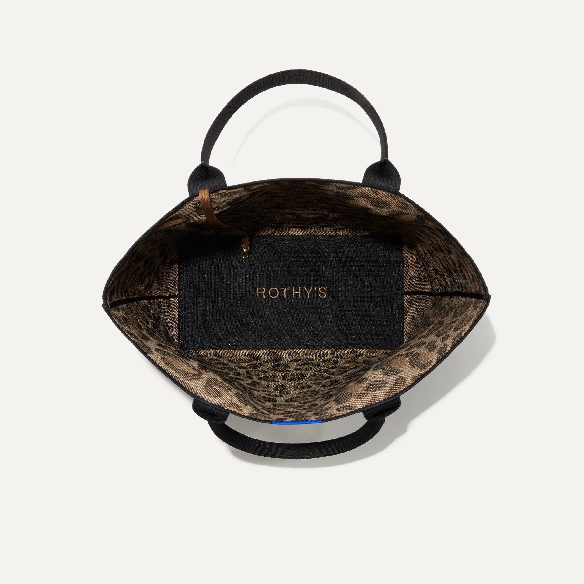 The Lightweight Tote in Desert Cat shown open from the top, with base insert visible. 