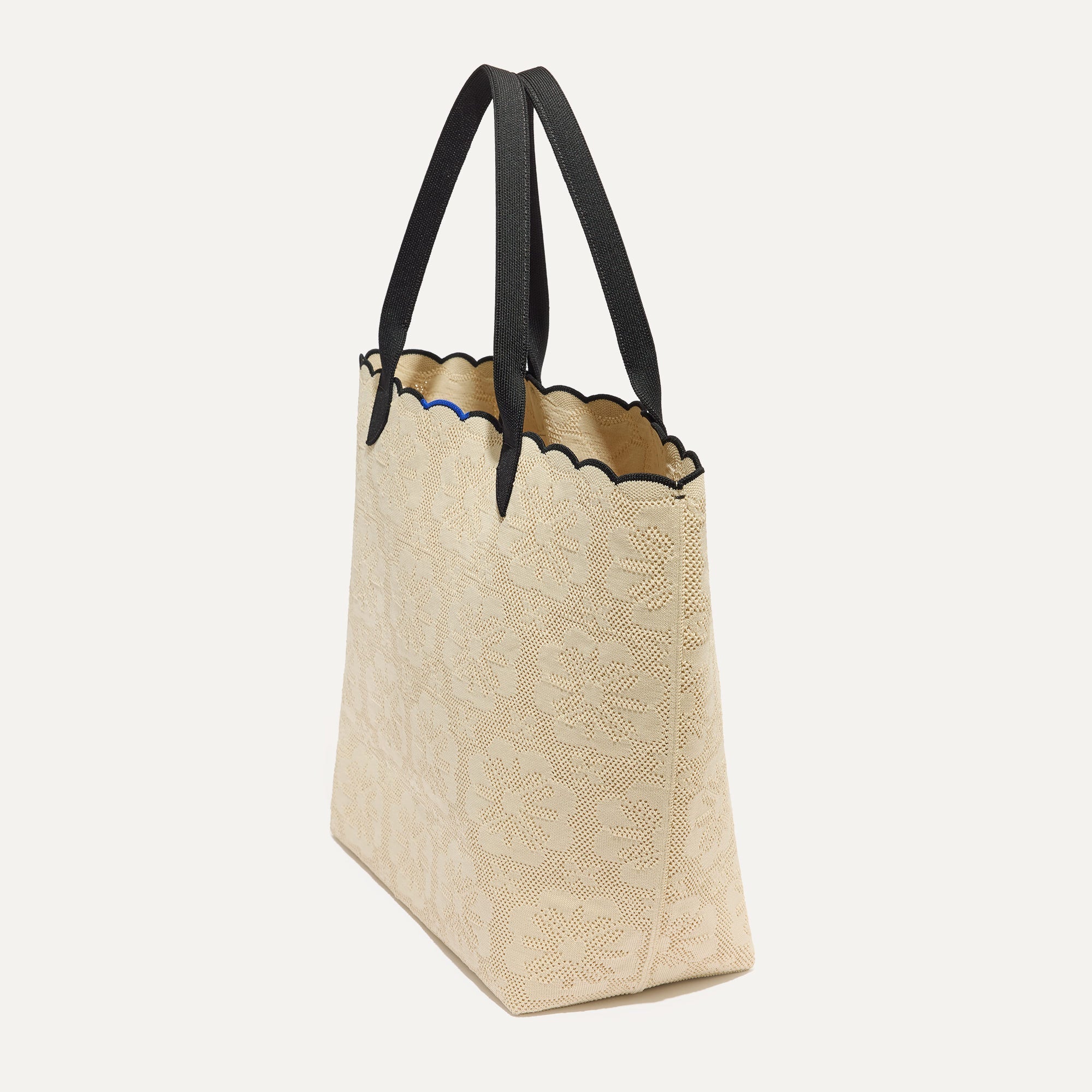 The Lightweight Tote in Ivory Scallop shown in diagonal view.