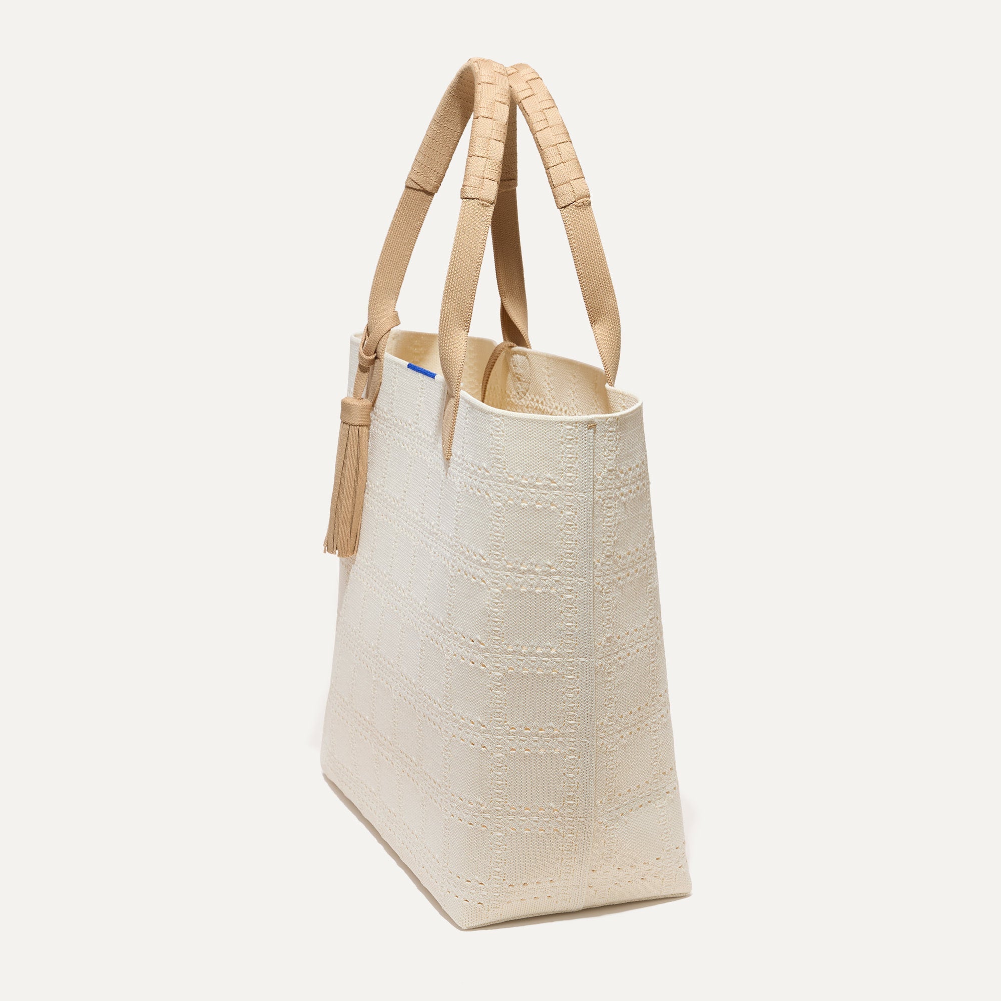 The Lightweight Tote in Ivory Perf shown in diagonal view.