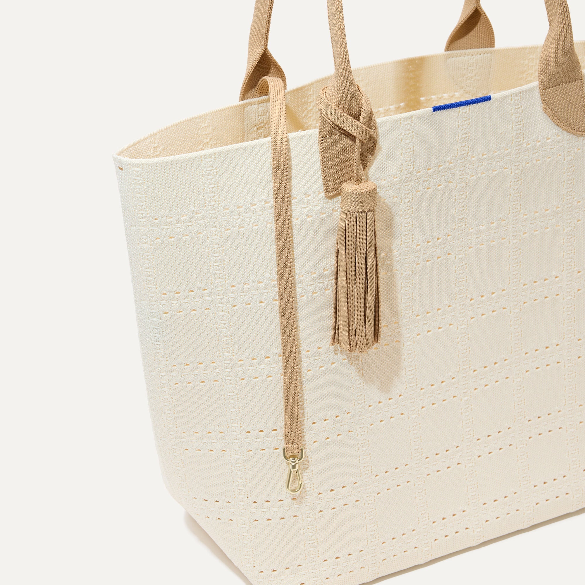 The Lightweight Tote in  Ivory Perf shown with its handy key leash.