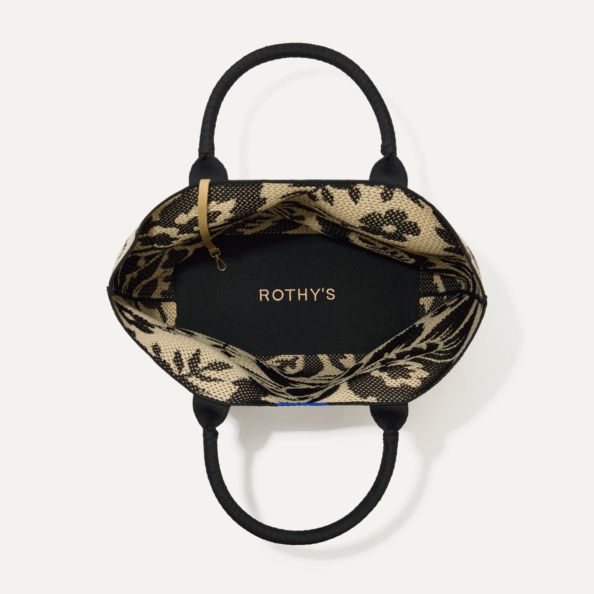 The Lightweight Tote in Jardin Black shown open from the top, with base insert visible. 