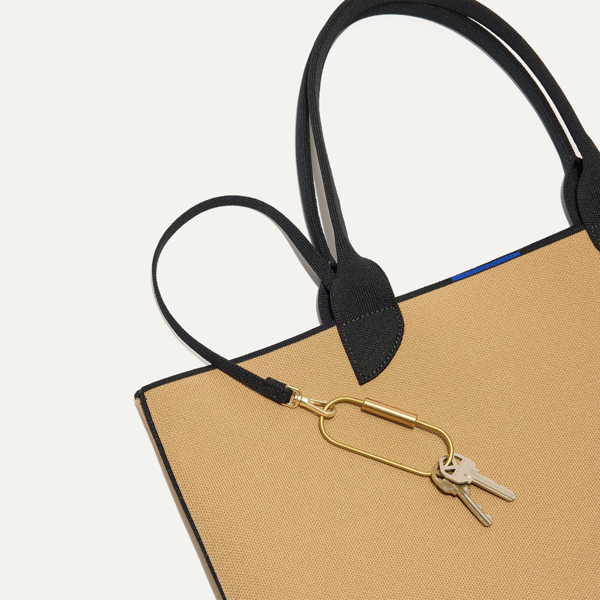 Close up of the handles and key leash detail of The Lightweight Tote in Shortbread.